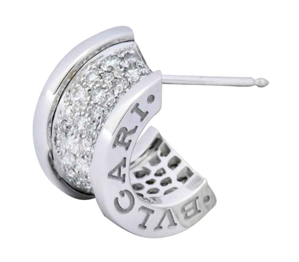 Featuring pave set round brilliant diamonds weighing approximately 1.50 carat total, F-G color and VS clarity

In highly polished white gold with post and push tension safety backs

Fully signed Bvulgari on wide edges and 750 for 18 karat gold on