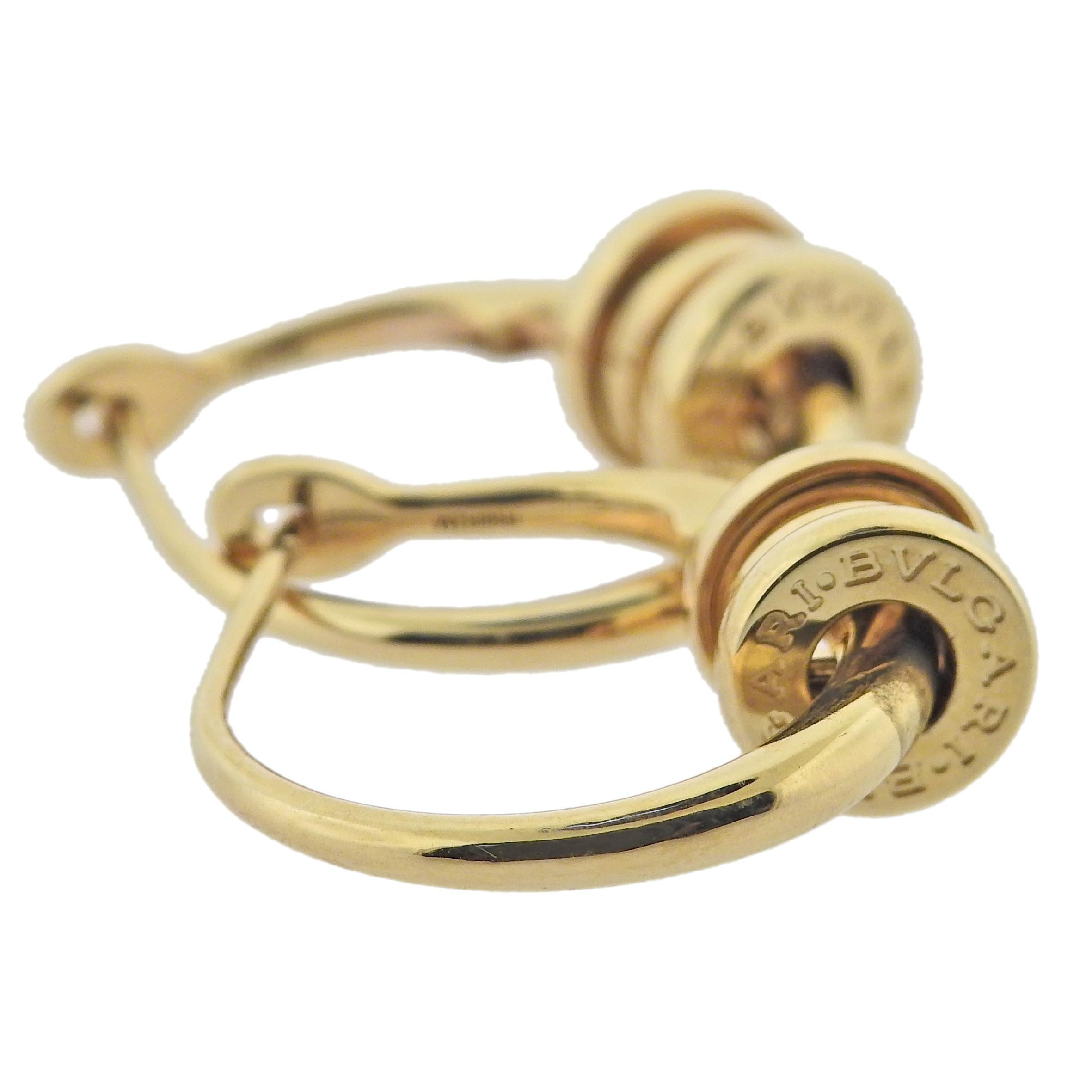 18k yellow gold hoop B.Zero1 earrings by Bvlgari. Retail $3100. Comes with COA and box.  Earrings are 20mm in diameter, charm is 8mm x 7mm. Marked Bvlgari, made in Italy, Italian mark, 750, Serial number. Weight 9.4 grams