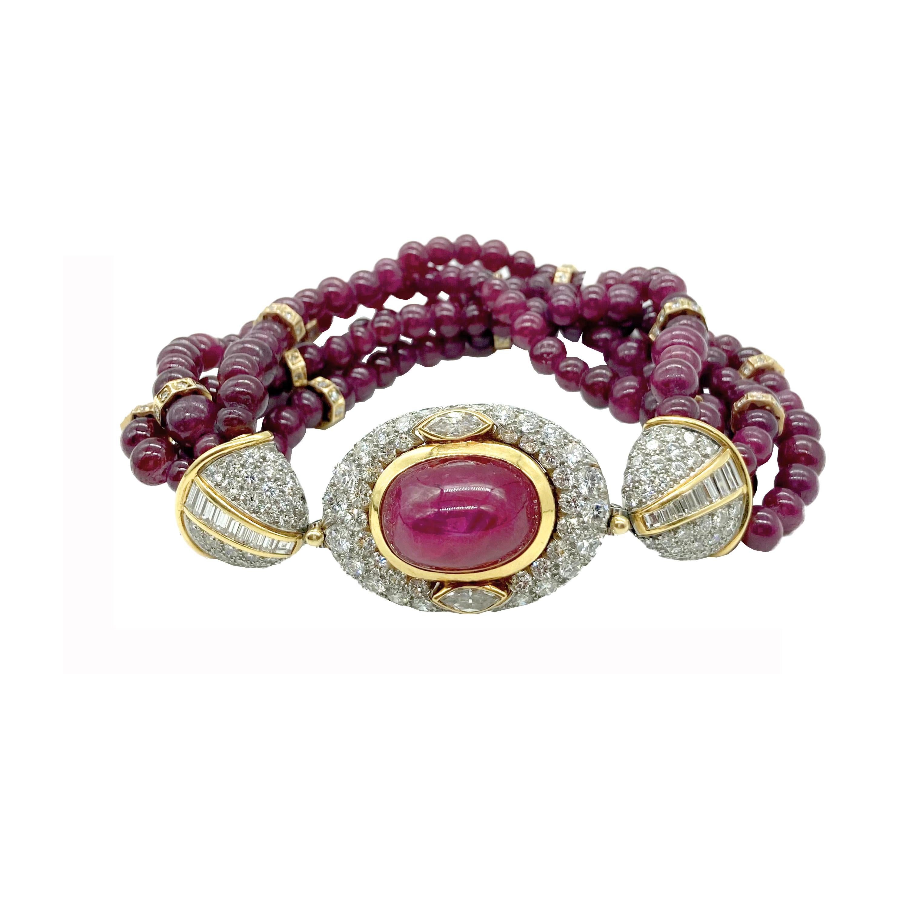 A glamorous Bulgari torsade bracelet centering a cabochon Burmese ruby embellished by diamonds, with a body of ruby beads. in 18 karat yellow gold and platinum. Circa 1980s. Made in Italy.