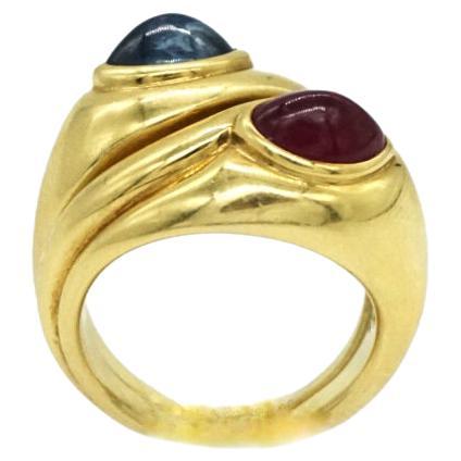 Bulgari 18 karat yellow gold and 4.49 carat cabochon ruby ring paired with a 4.53 carat cabochon sapphire ring. Made in Italy, circa 1970.
