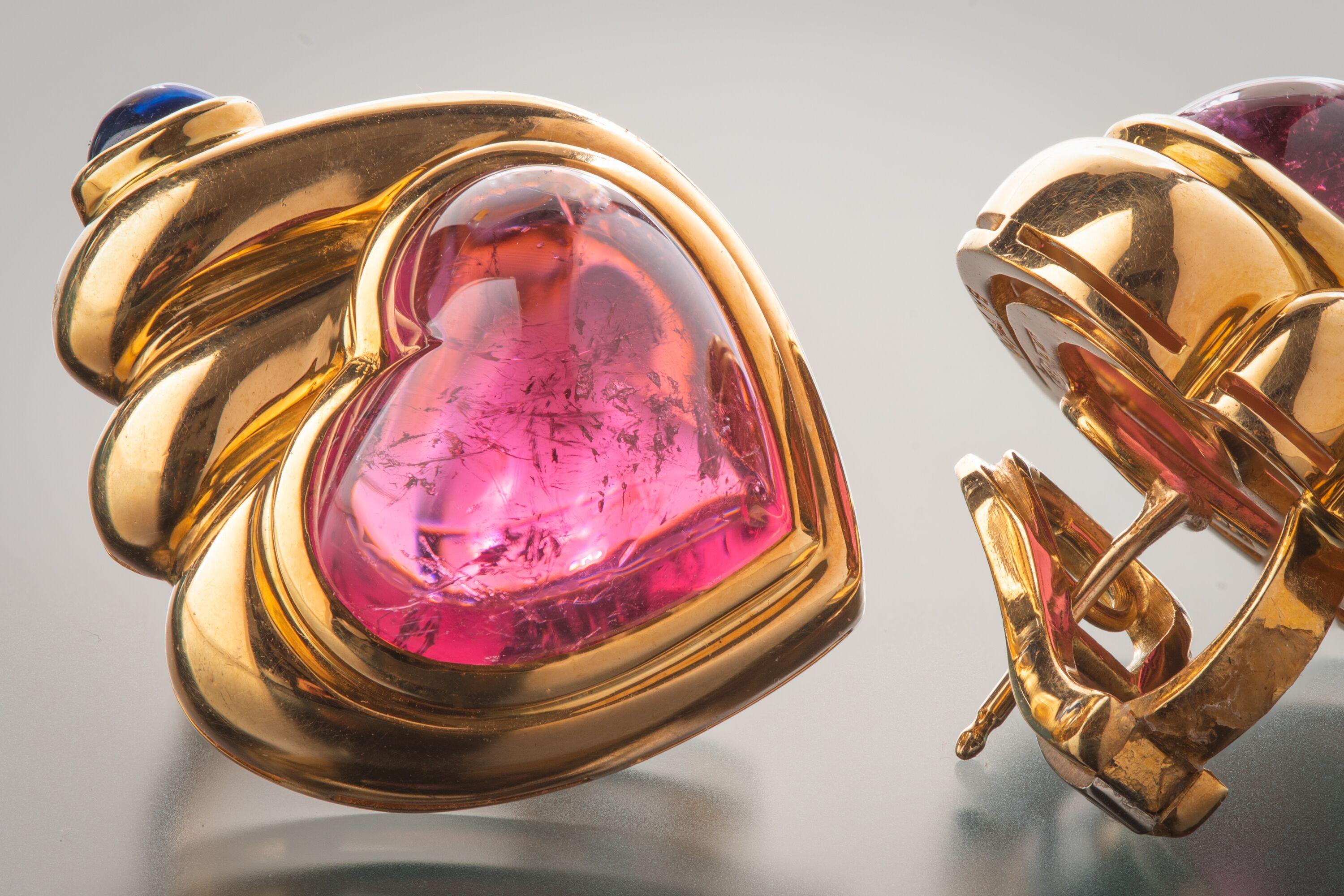 The Bulgari brand is defined by its distinctive and vibrant color combinations. In these earrings pink heart-shaped cabochon tourmalines are set into 18k polished yellow gold swirls punctuated by single bezel-set blue sapphires. 

Length
