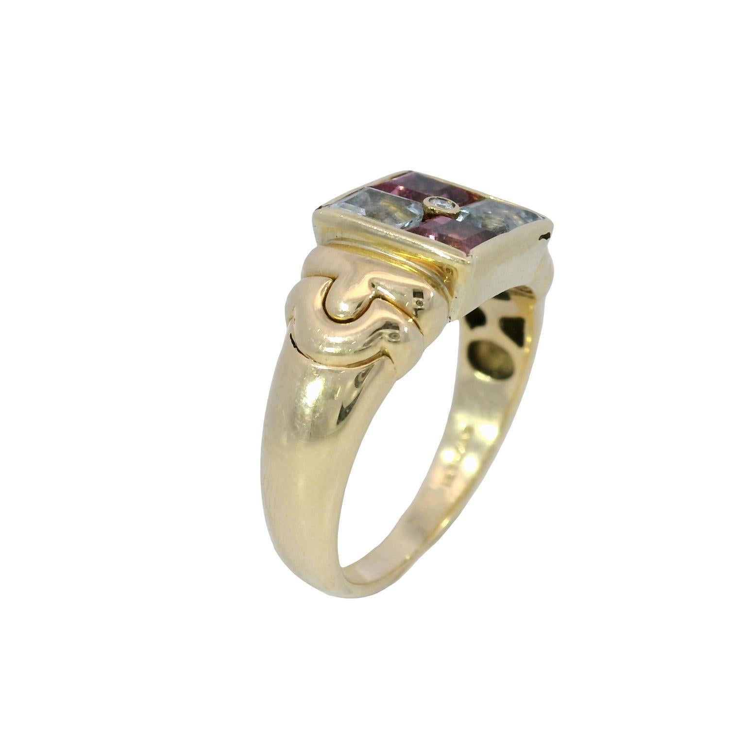 Bvlgari 18K Gold Statement Ring with Aquamarine and Tourmaline

This 18k yellow gold ring by Bvlgari features a bold geometric design, centered around a square arrangement of aquamarine and pink tourmaline. The aquamarine stones exhibit a cool blue