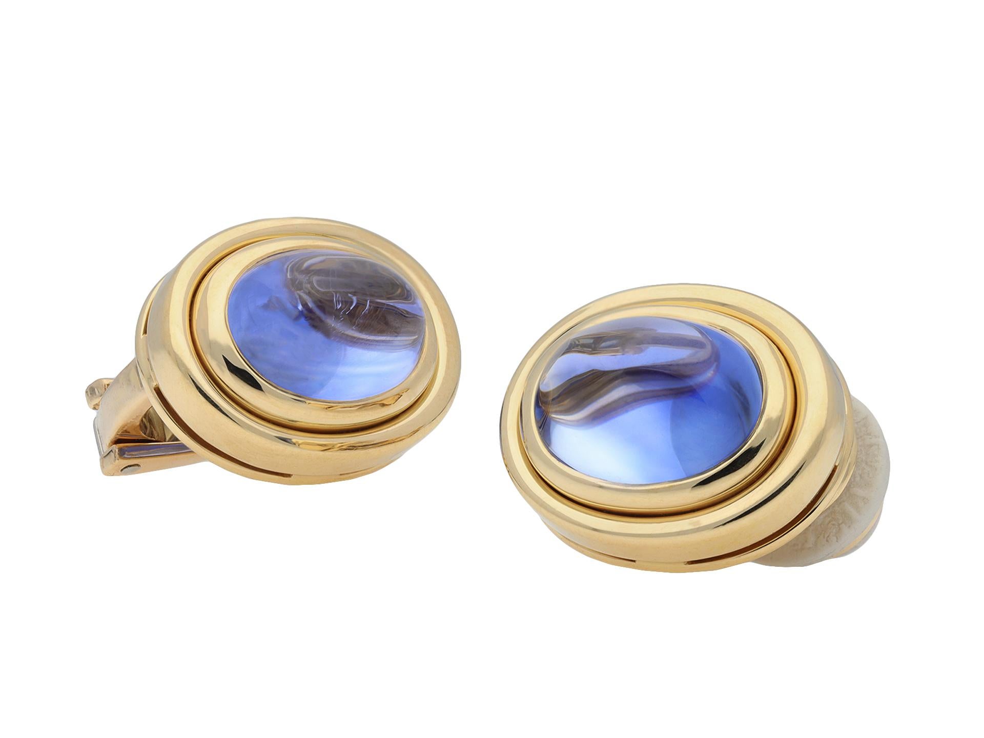 Bulgari Ceylon sapphire earrings. A matching pair of earrings, each composed of an oval cabochon natural unenhanced Ceylon sapphire in an open back rubover setting, two in total with a combined approximate weight of 10.87 carats, to a striking
