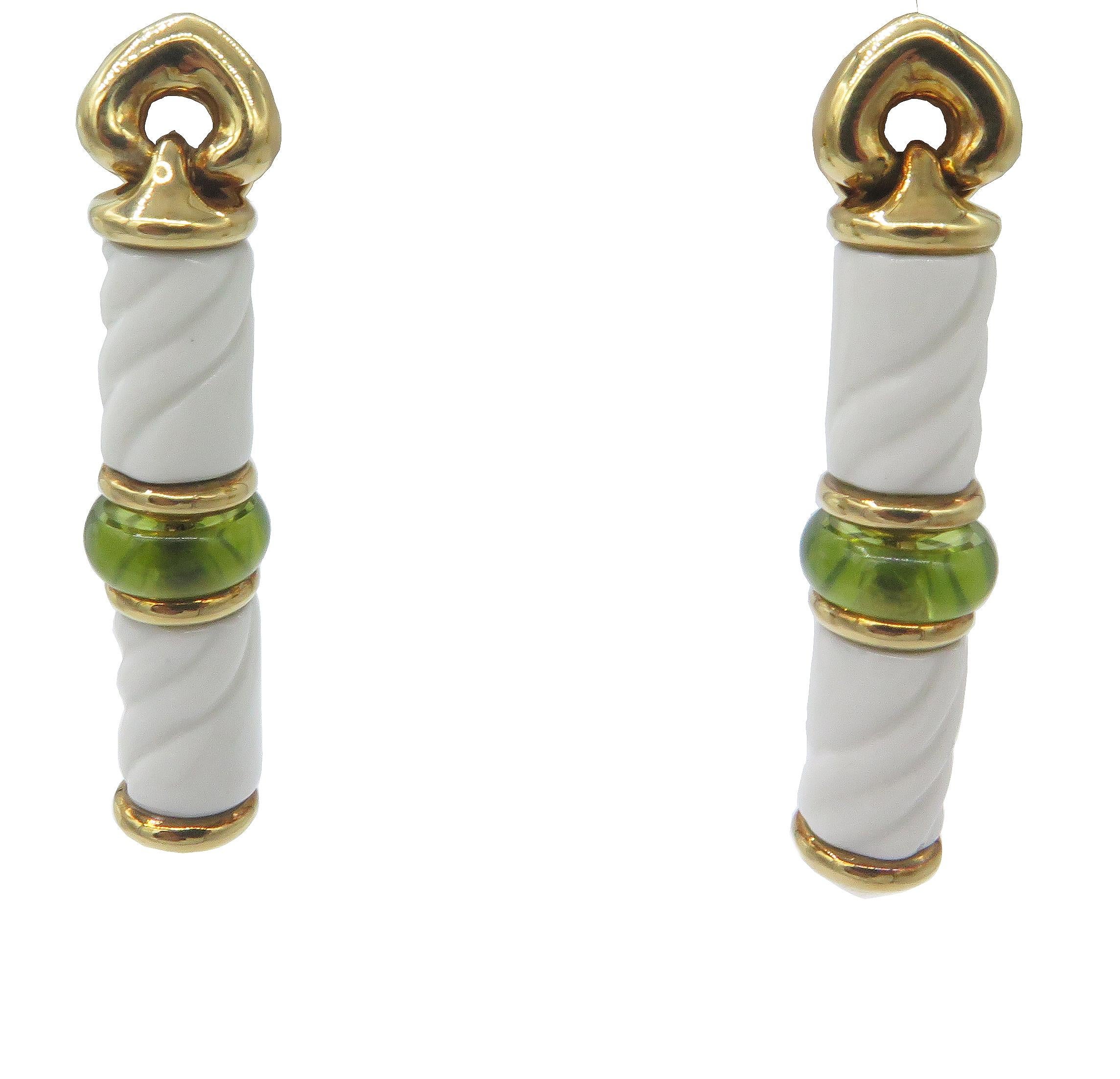 A stunning pair of Bulgari 18k yellow gold and white ceramic drop earrings with a peridot disc in the middle of two beautifully textured ceramic bars. They are from the early 1990’s Bulgari Chandra Collection. The earrings are 1.75 in. long and