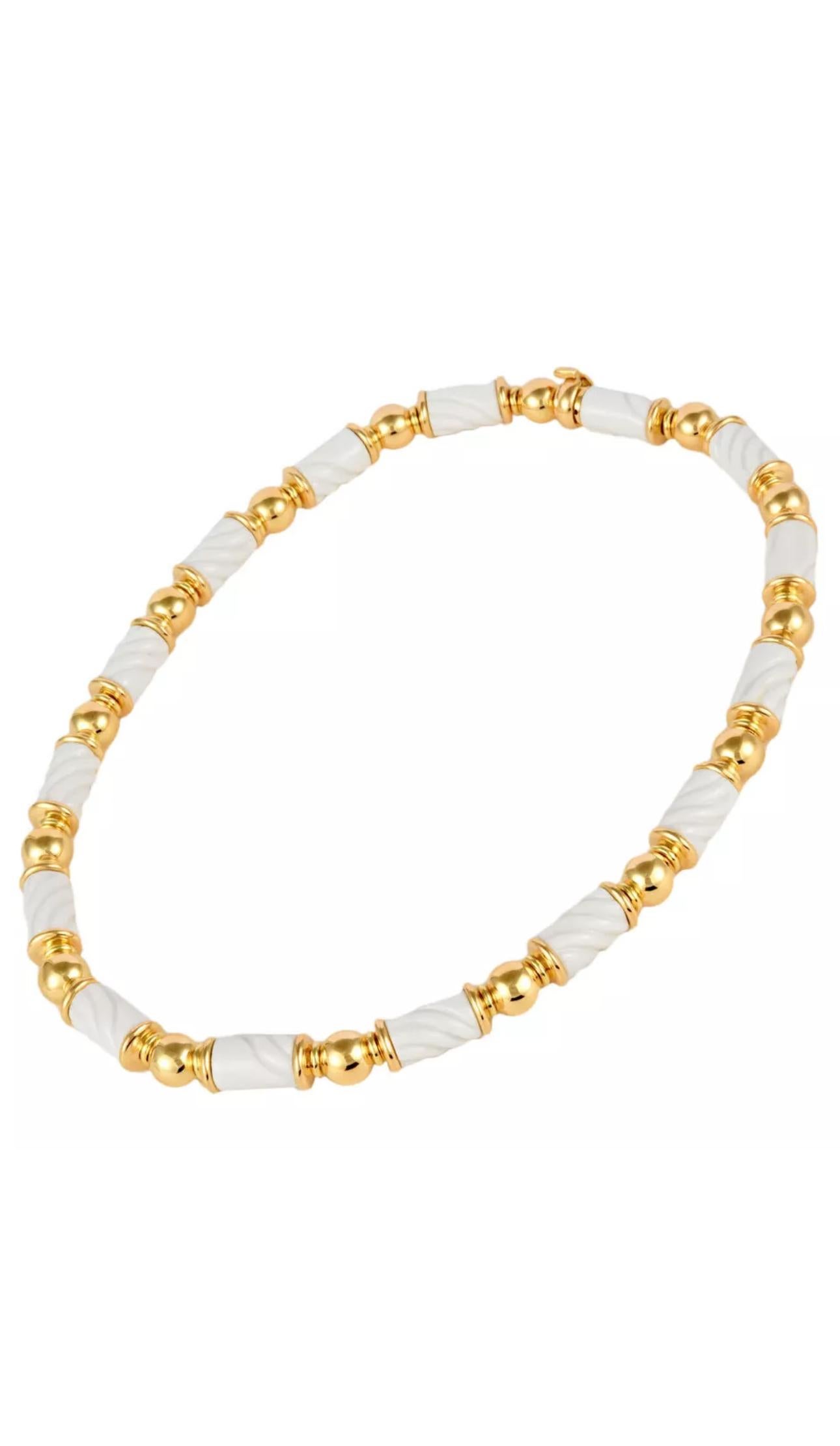 A beautiful set in 18k yellow gold and white porcelain, comprising necklace and pendant earrings. 
Signed Bulgari, from the popular “Chandra” collection, Made in Italy, circa 1990.
Designed as a series of part textured porcelain spheres, signed