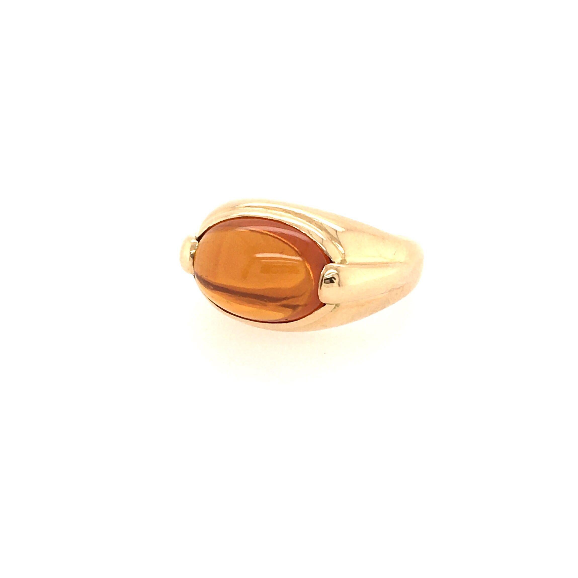 An 18 karat yellow gold and citrine ring. Bulgari. Circa 1990. Of polished tapered bombe design, centering a horizontally set cabochon citrine. Size 5 1/2, gross weight is approximately 11.6 grams. Stamped Bulgari. 