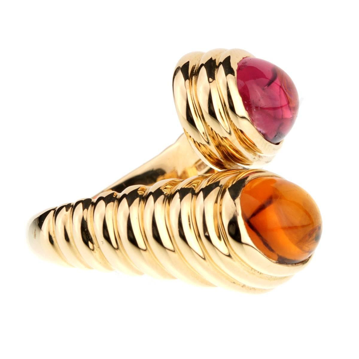 A timeless Bulgari ring featuring a cabochon tourmaline and citrine stone set in 18k yellow gold. Ring Width .74