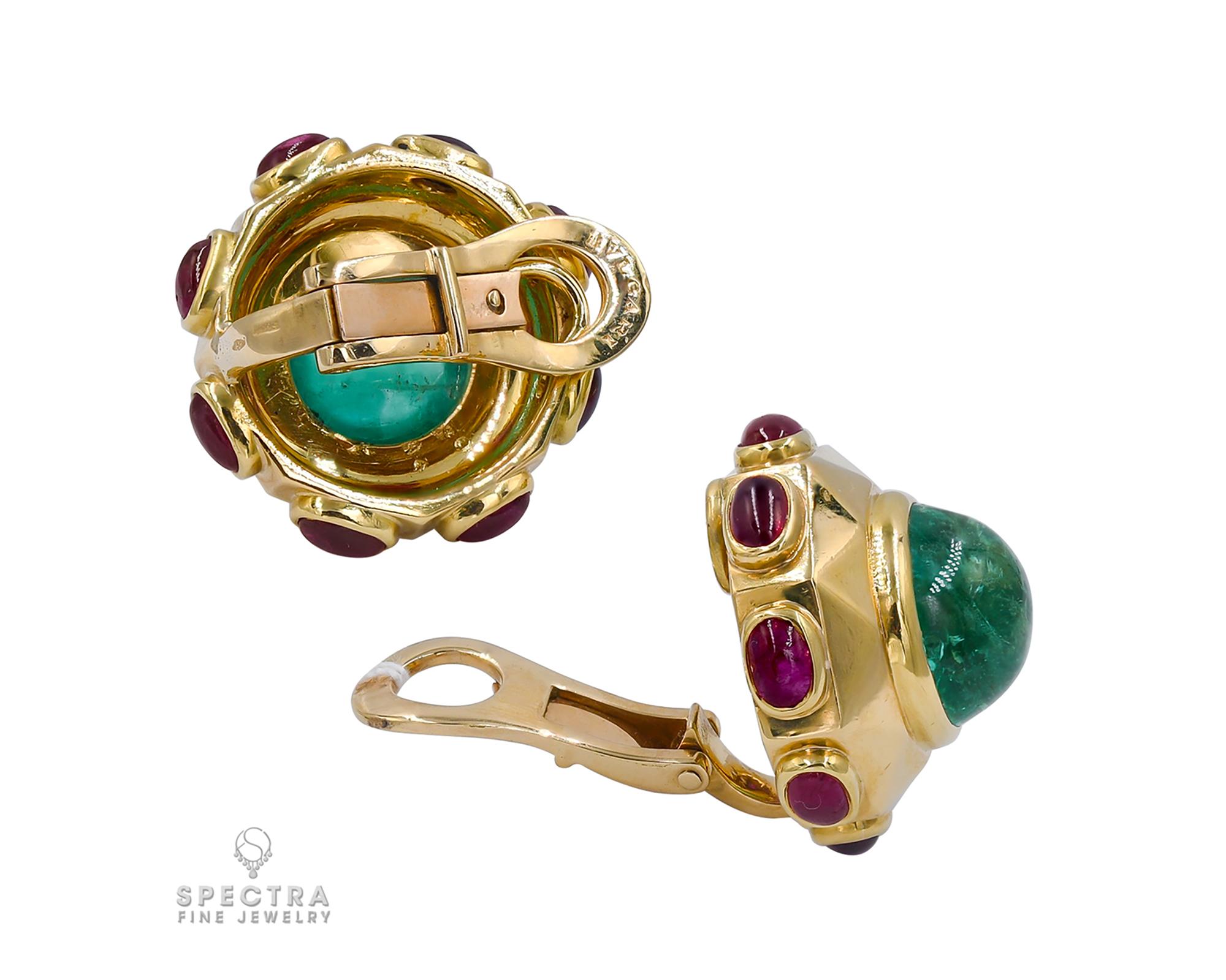 A pair of earrings set with Colombian cabochon emeralds and rubies, made by Bulgari.
Weight of emeralds is approximately 8 carats. 
Circa 1980.
Metal is 18k yellow gold, gross weight is 24.14 gr.
Clip-on style.
Signed Bvlgari.
