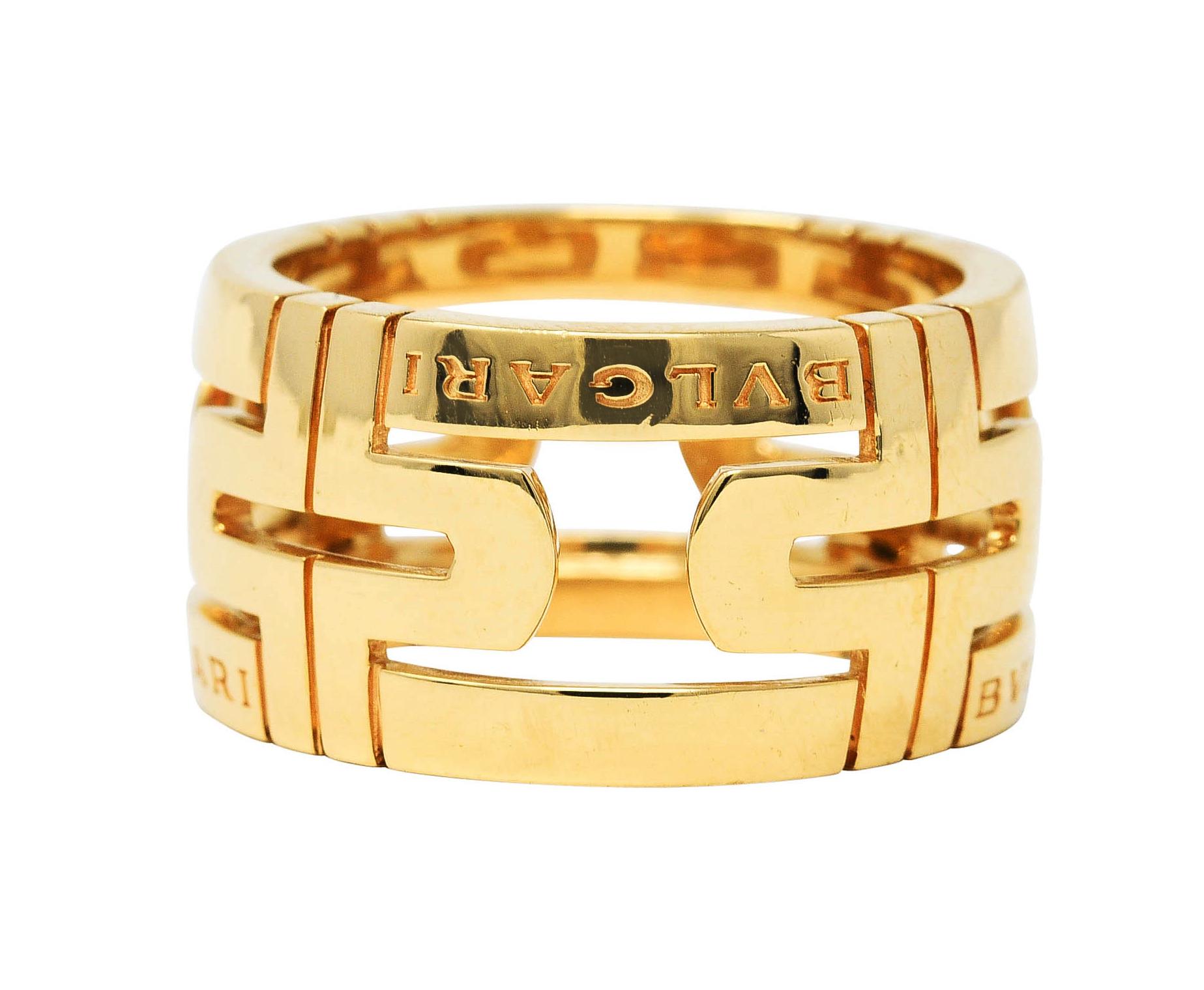 Wide band ring is deeply grooved and pierced with a geometric motif

With the Bvlgari signature front facing and repeated

From the contemporary Parentesi collection

Stamped 'Made in Italy' with Italian assay marks for 18 karat gold

Fully signed