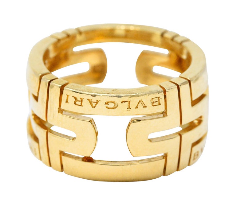 Wide band ring is deeply grooved and pierced with a geometric motif

With the Bvlgari signature front facing and repeated

From the contemporary Parentesi collection

Stamped 'Made in Italy' with Italian assay marks for 18 karat gold

Fully signed