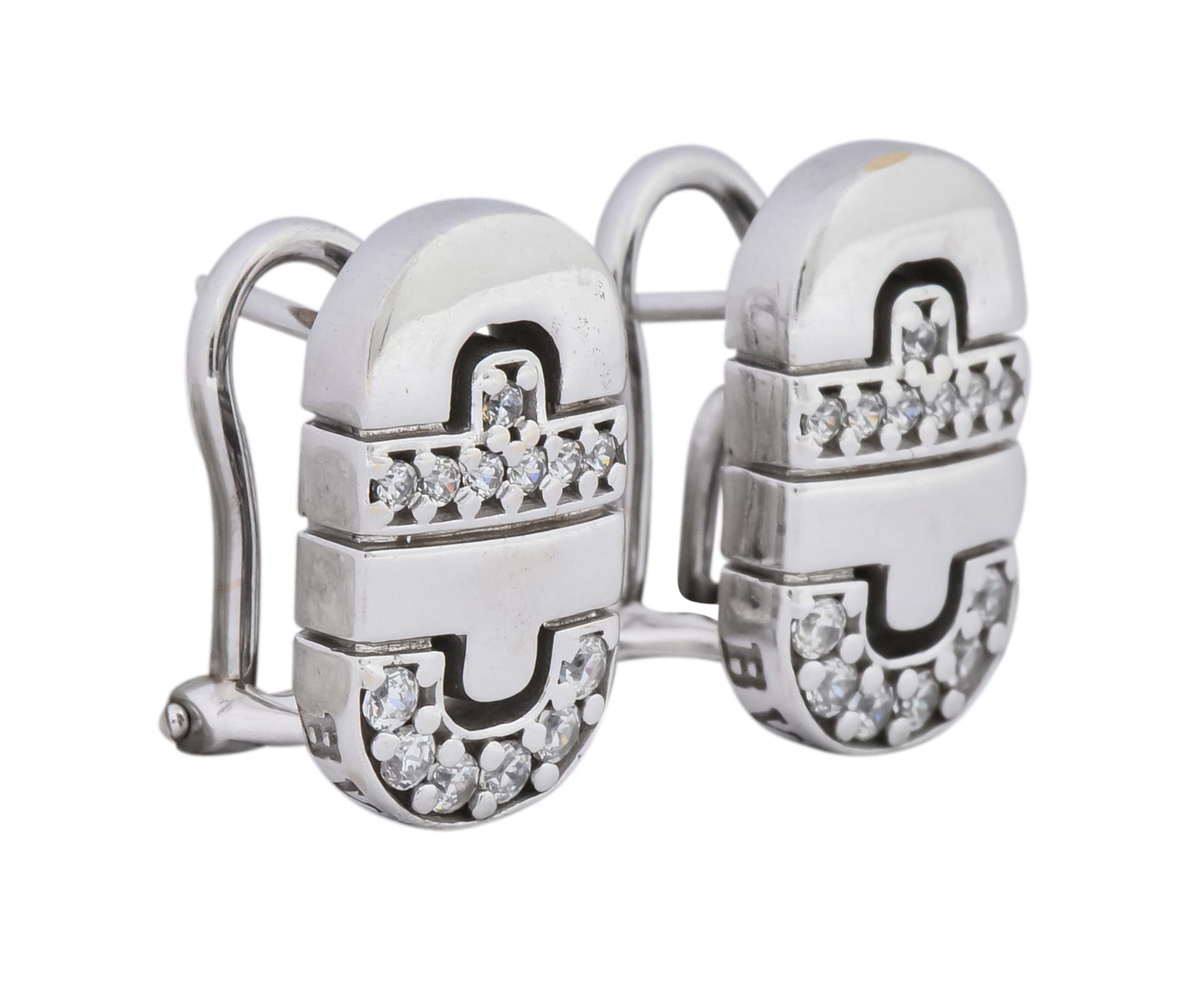 Earrings designed as rounded rectangular shapes featuring half circle and bar Parentesi motif
Accented by, bead set, round brilliant cut diamonds weighing approximately 0.25 carat total, G/H color and VS clarity

Completed by hinged omega backs and