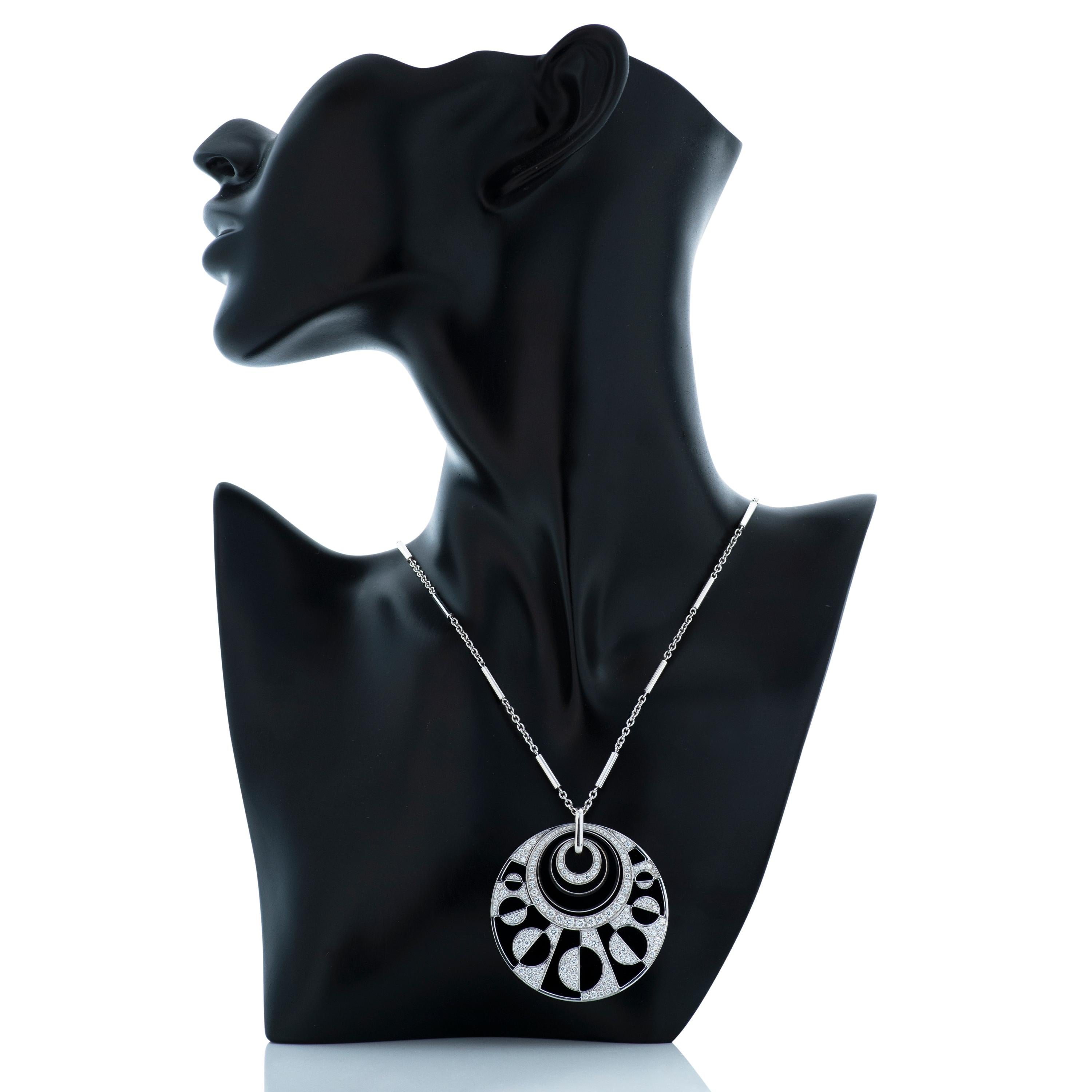 Bulgari 18kwg diamond and onyx disc pendant with adjustable length necklace chain, from the Intarsio collection.

This pendant includes approximately 2.98 carats of round brilliant cut diamonds, contrasted by geometric shaped pieces of black onyx. 