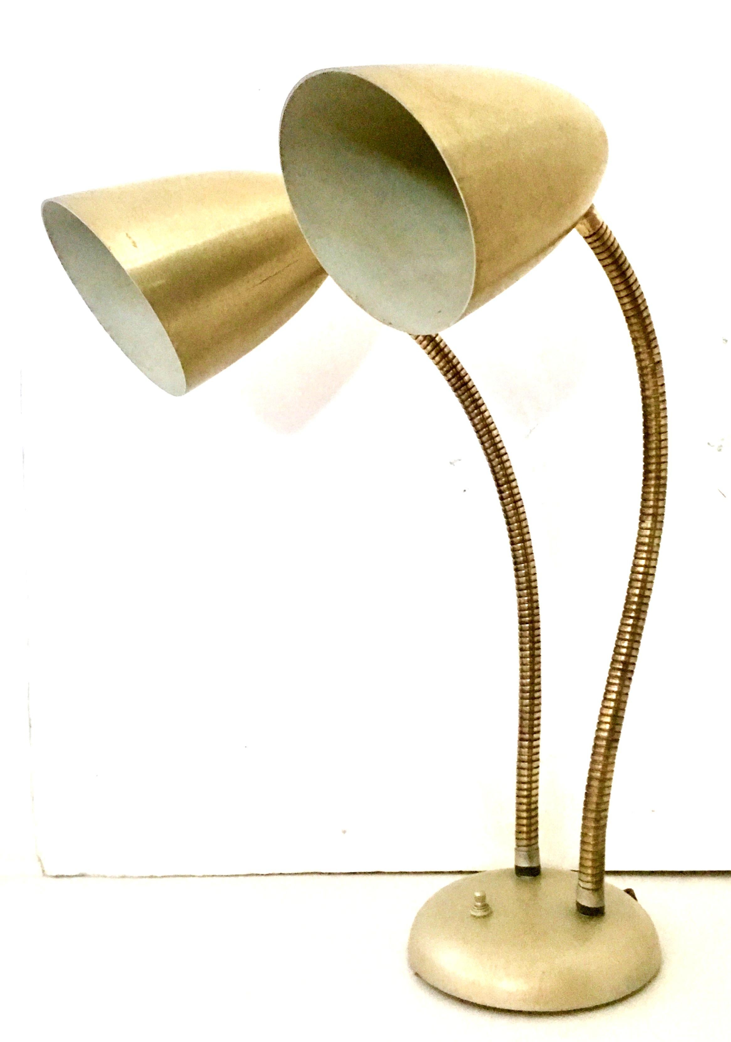 1950'S Gold metal enamel double cone shade goose neck lamp by Prescolite-USA. This double cone shade metal and brass gold goose neck lamp features 360 degree pivoting brass coil arms, a three way switch at the base and accommodates standard three
