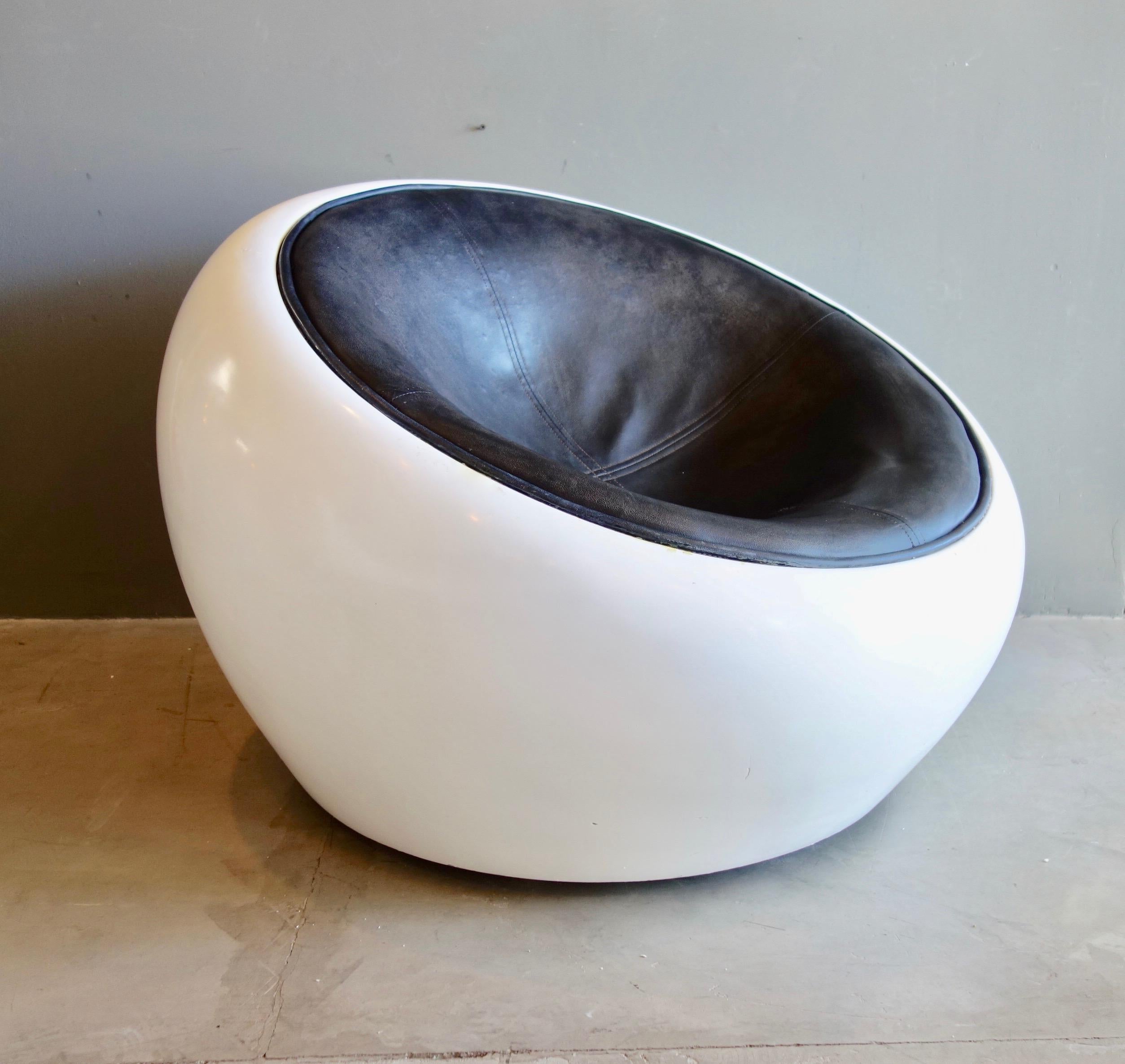 Amazing pair of white fiberglass pod chairs with black leather circular seats. Great scale. Stylish yet comfortable chairs that make a giant statement in your living space. So cool!

 
