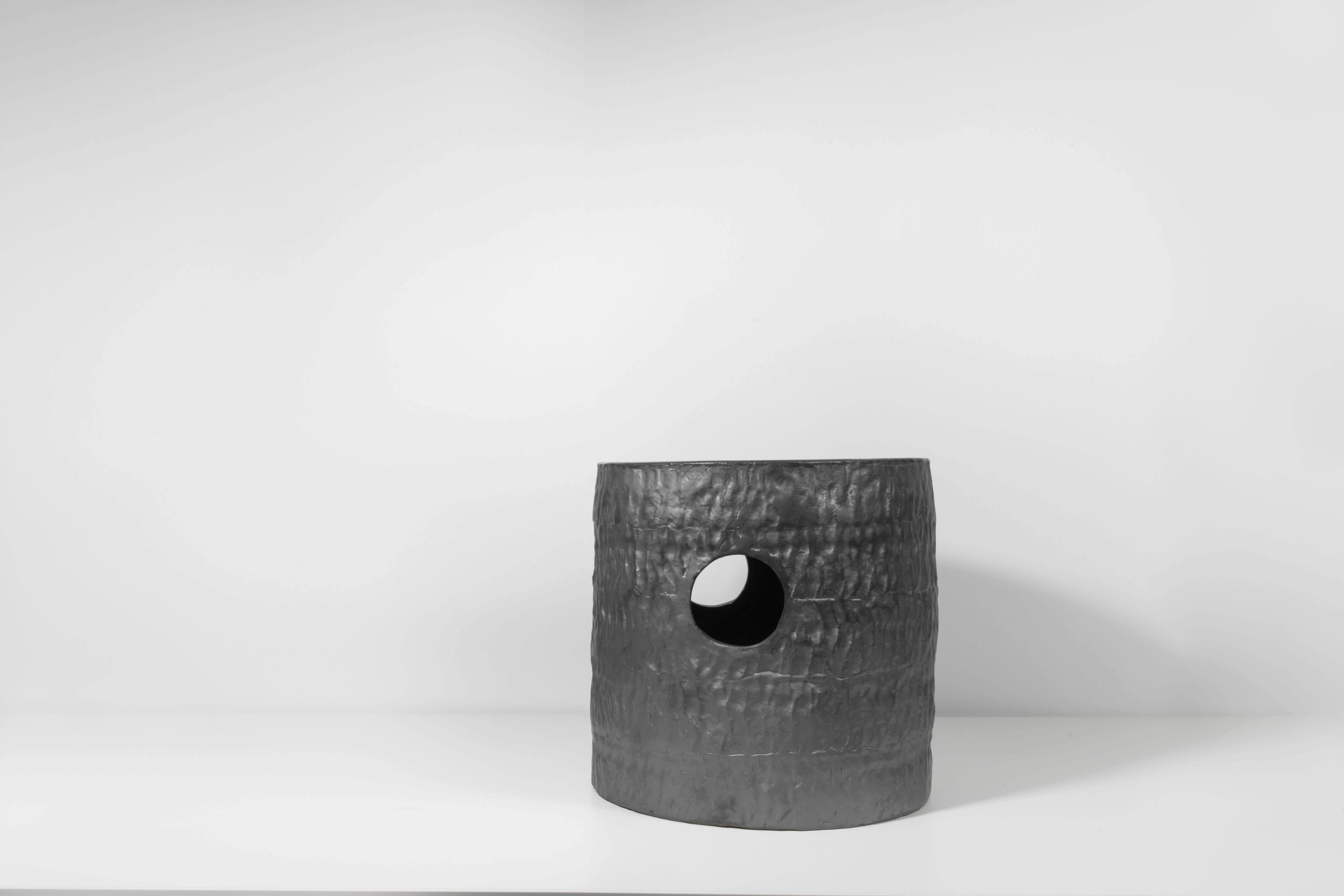 Coil-built ceramic stool with black coppered glaze. Marked with an engraved bronze label to underside: Jonathan Nesci w/ Robert Pulley 18/16. 

Designed by Jonathan Nesci and made in Columbus, Indiana by local ceramist Robert Pulley for inaugural