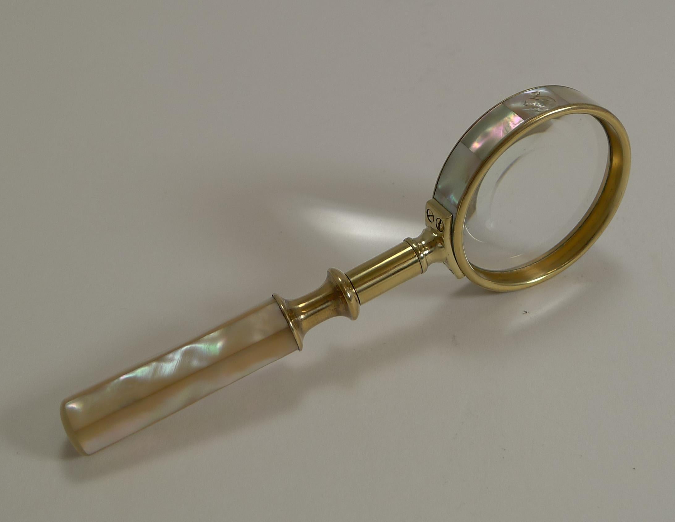 A small and versatile example, elegant for the desk top but still small enough to take out and about.

Made from solid English brass with a good quality screwed construction, the handle and the outside of the lens are both covered in tiles of