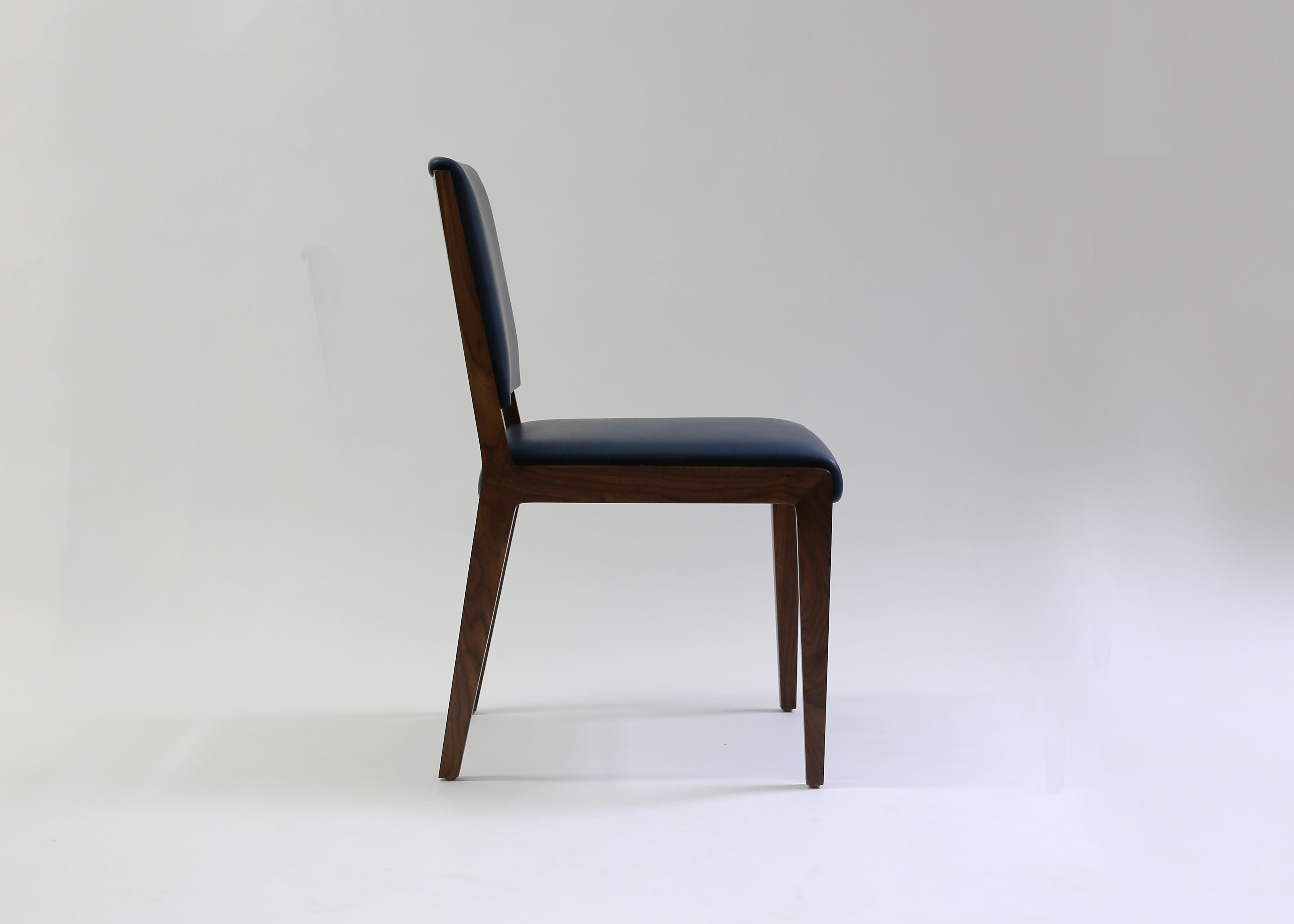 The Nevin dining chair from Lf upholstery is a comfortable and beautifully crafted side chair that can double as both a dining chair and game chair, shown in blue leather with soft foam on back and seat with hand-carved mahogany wood frame.
ITEM IS