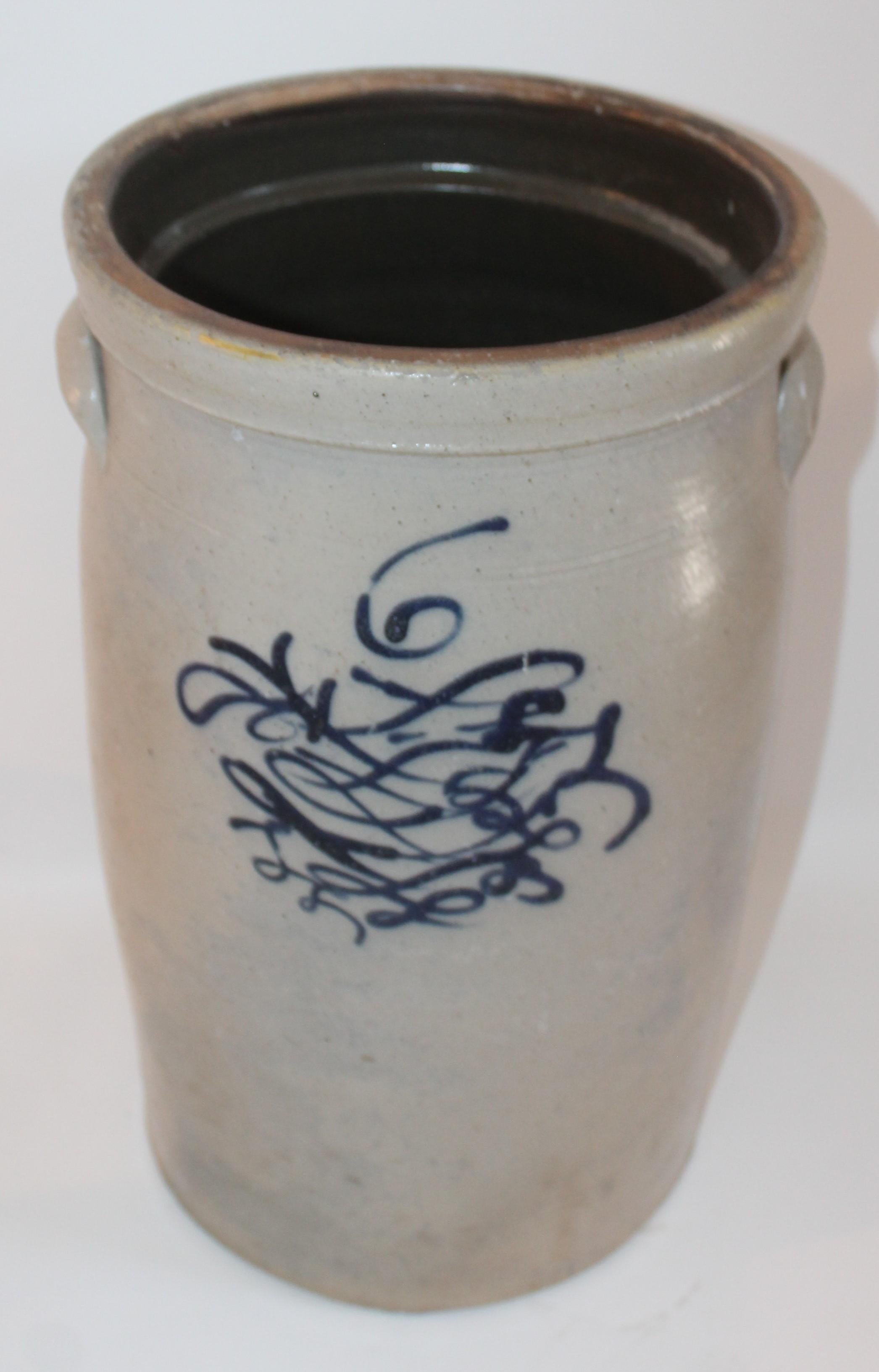 This fine butter churn has the salt glaze and blue decoration with a number six on the face of the crock. It has the doubled handles in fine condition.