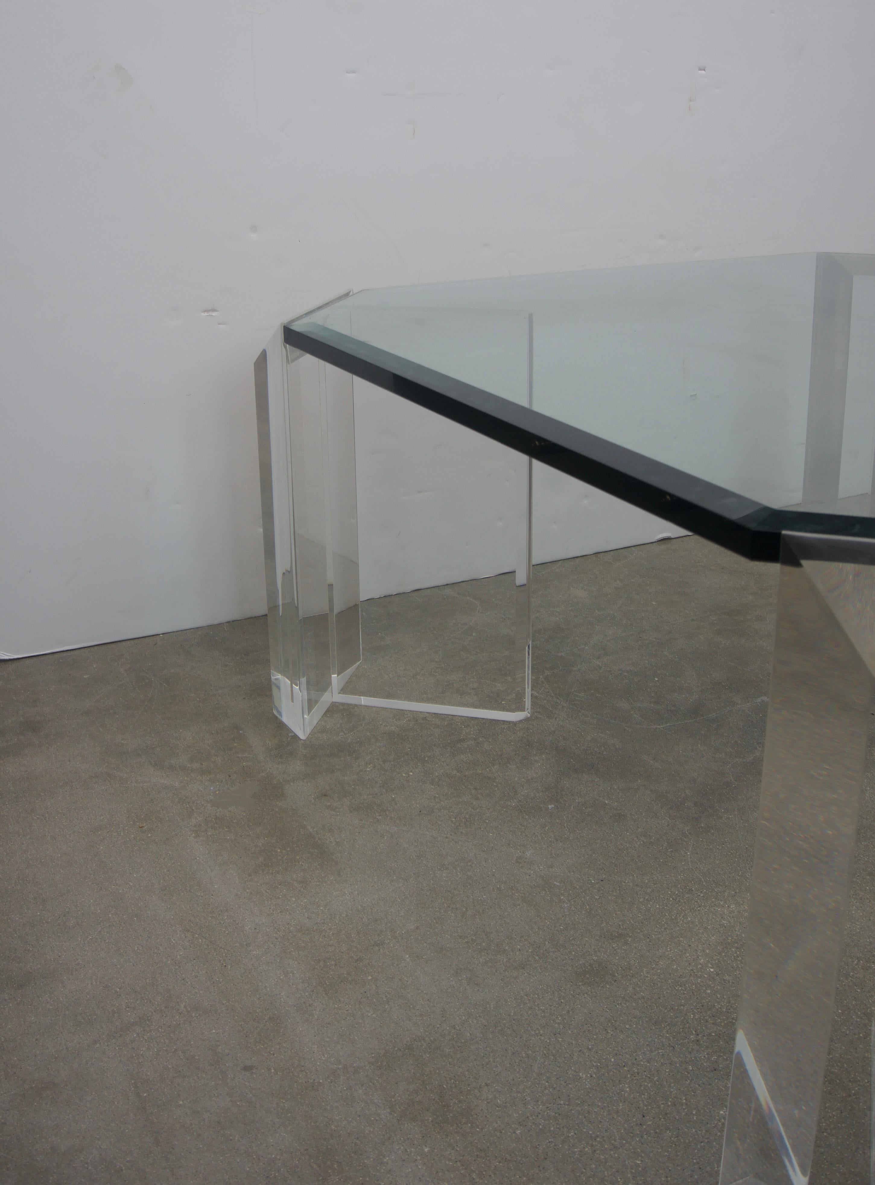 This stylish and chic Lucite and glass cocktail table is by the iconic American designer Charles Hollis Jones and it date to the 1970s-1980s. The cut-corner detail softens the piece and of course no bumping into a sharp corner of glass.
