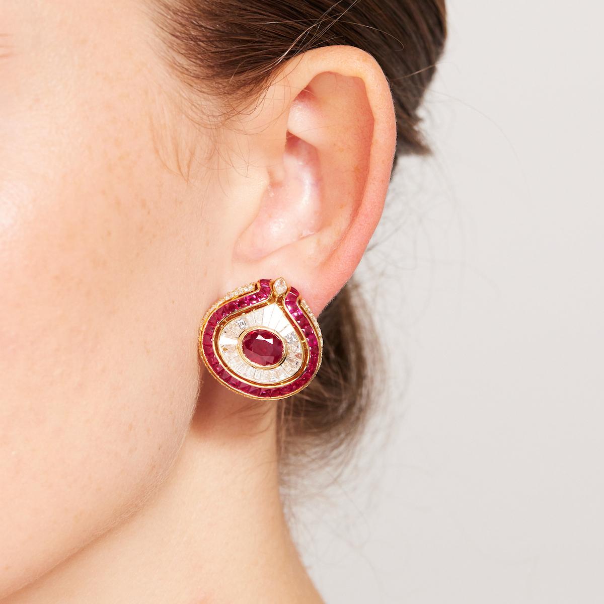 Exceptional and highly collectible 1980s Bulgari earrings of bombe design, each centering on a vivid-red Burma ruby (approximately 2.5 carats each) and showcasing another 6 carats of very fine white diamonds, all set in 18 karat yellow gold. Two