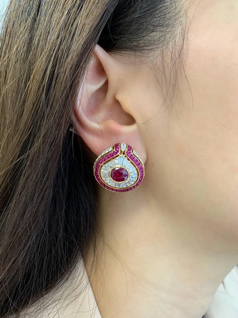 Exceptional and highly collectible 1980s Bulgari earrings of bombe design, each centering on a vivid-red Burma ruby (approximately 2.5 carats each) and showcasing another 6 carats of very fine white diamonds, all set in 18 karat yellow gold. Two