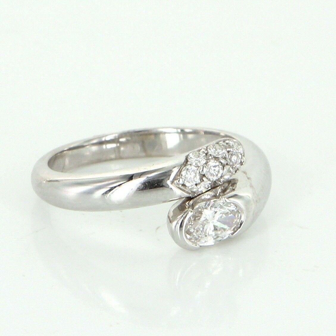 Elegant Bulgari diamond bypass ring, crafted in 18 karat white gold. 

Diamonds total an estimated 0.68 carats (estimated at F-G color and VVS2 clarity). The center oval cut diamond is estimated at 0.45 carats.

The ring is in excellent condition.
