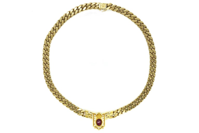An 18kt yellow gold chain necklace with diamonds, centering a cabochon ruby. By Bulgari, made in Italy (circa 1970).