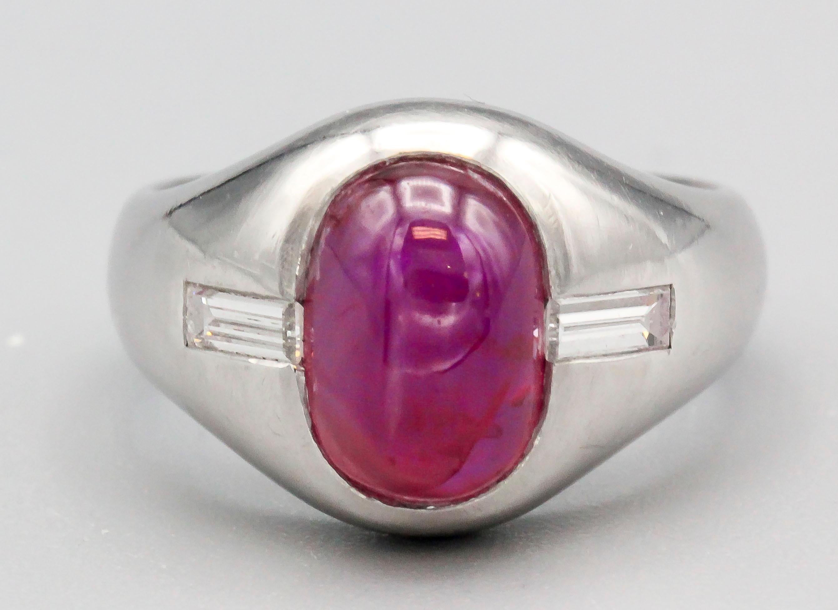 Fine cabochon star ruby and diamond ring by Bulgari, circa 1970s. Set in platinum, it features a rich red 3.23 carat cabochon ruby as its center stone, with high grade baguette cut diamonds on sides. Approx. size 5.5 and can be sized up or down if