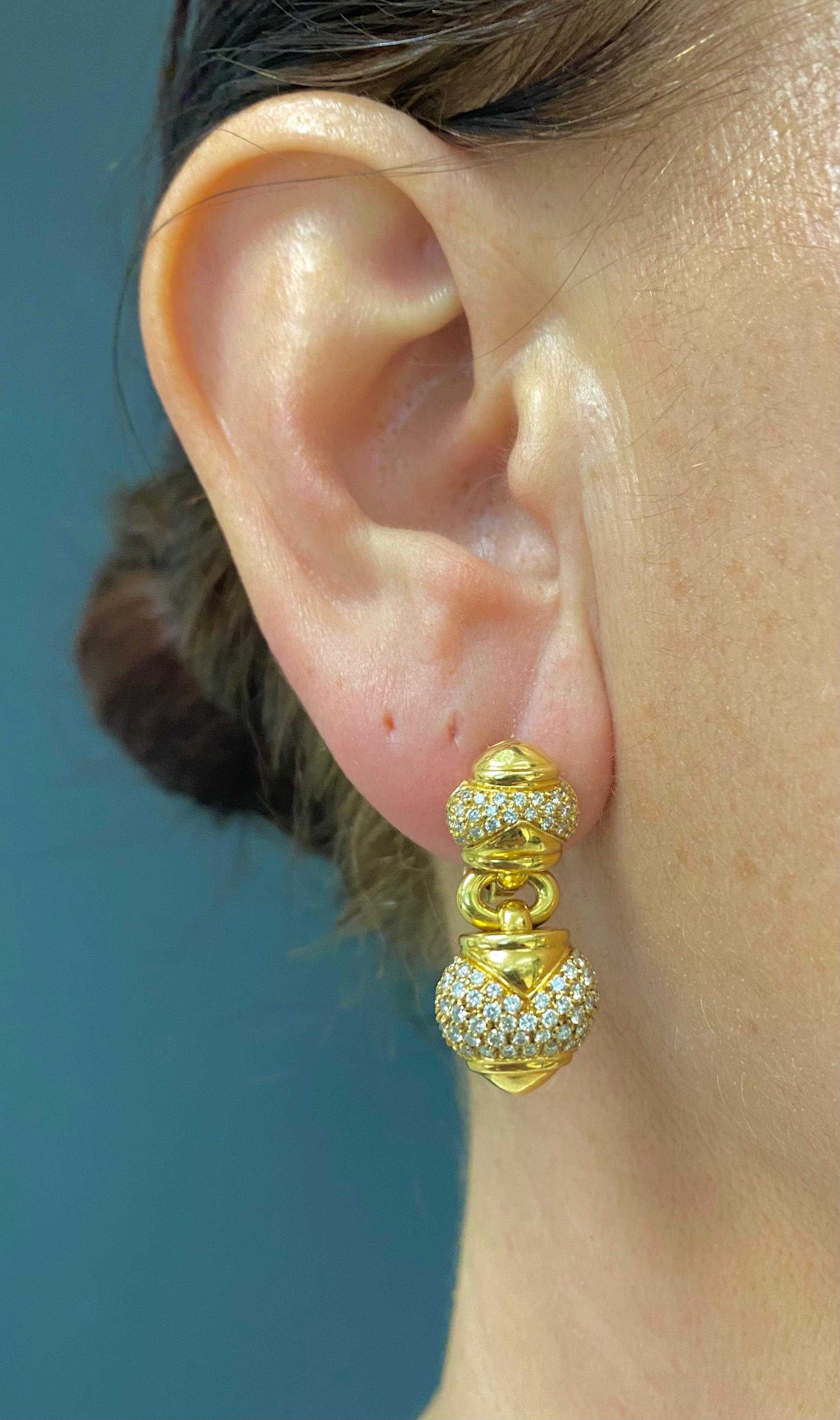 A pair of Bulgari diamond earrings from the Chandra collection, made of 18k gold. 
	These Bulgari earrings comprises a domed element on the top, a dangling heart-shaped part, and a ring that connects them together. Two gold “arrows” are set on both