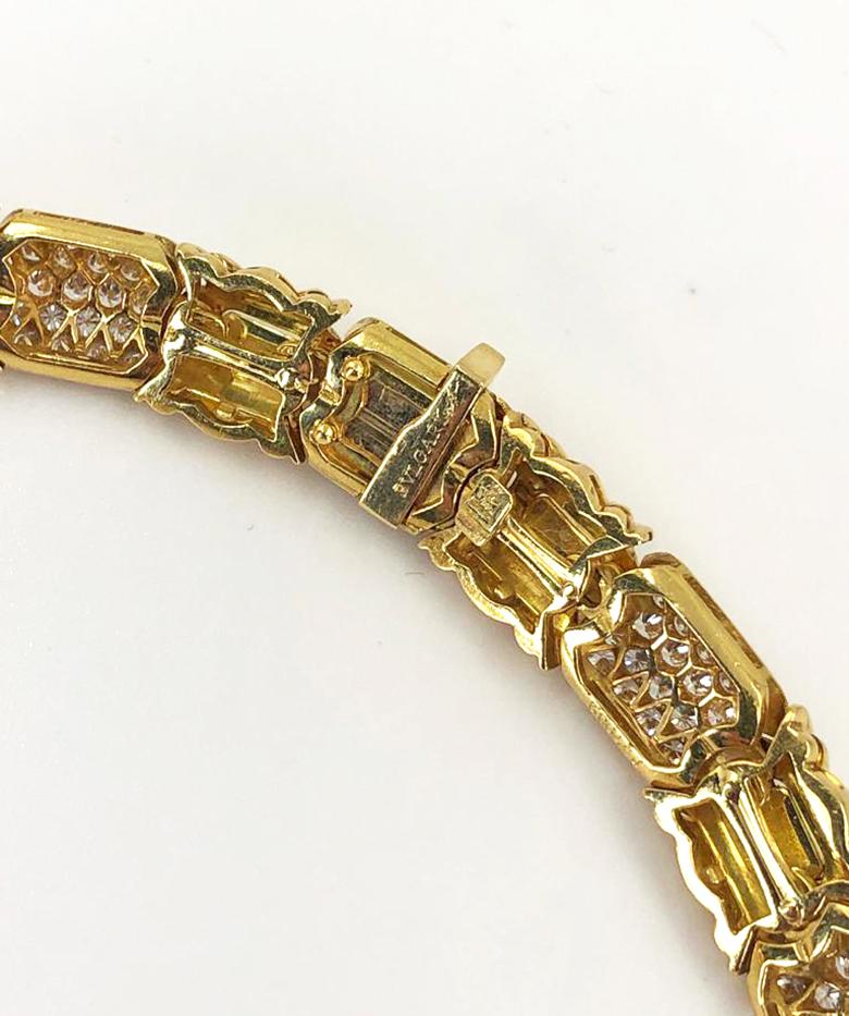 A vintage Bulgari 18k gold and diamond collar necklace of geometric design, set with approximately 20 carats of brilliant-cut diamonds around smooth polished gold links.

Signed Bulgari.