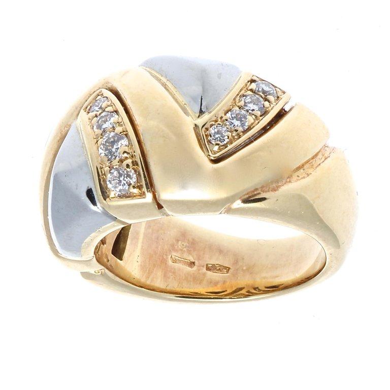 During the 80's & 90's Bulgari's design crystalized into a recognizable image of gold, volume, color and clean shapes. This ring features uniquely weaving white and yellow gold and columns of diamonds. Signed Bvlgari and numbered. Ring size 5-1/2