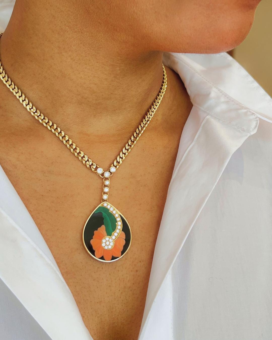 This lovely diamond, hard stone inlay, and 18-karat yellow gold pendant necklace was crafted by Bulgari in Italy circa 1972. It weighs 59.15 grams and measures 16” in length. The gorgeous, delicate necklace showcases a design that combines fine