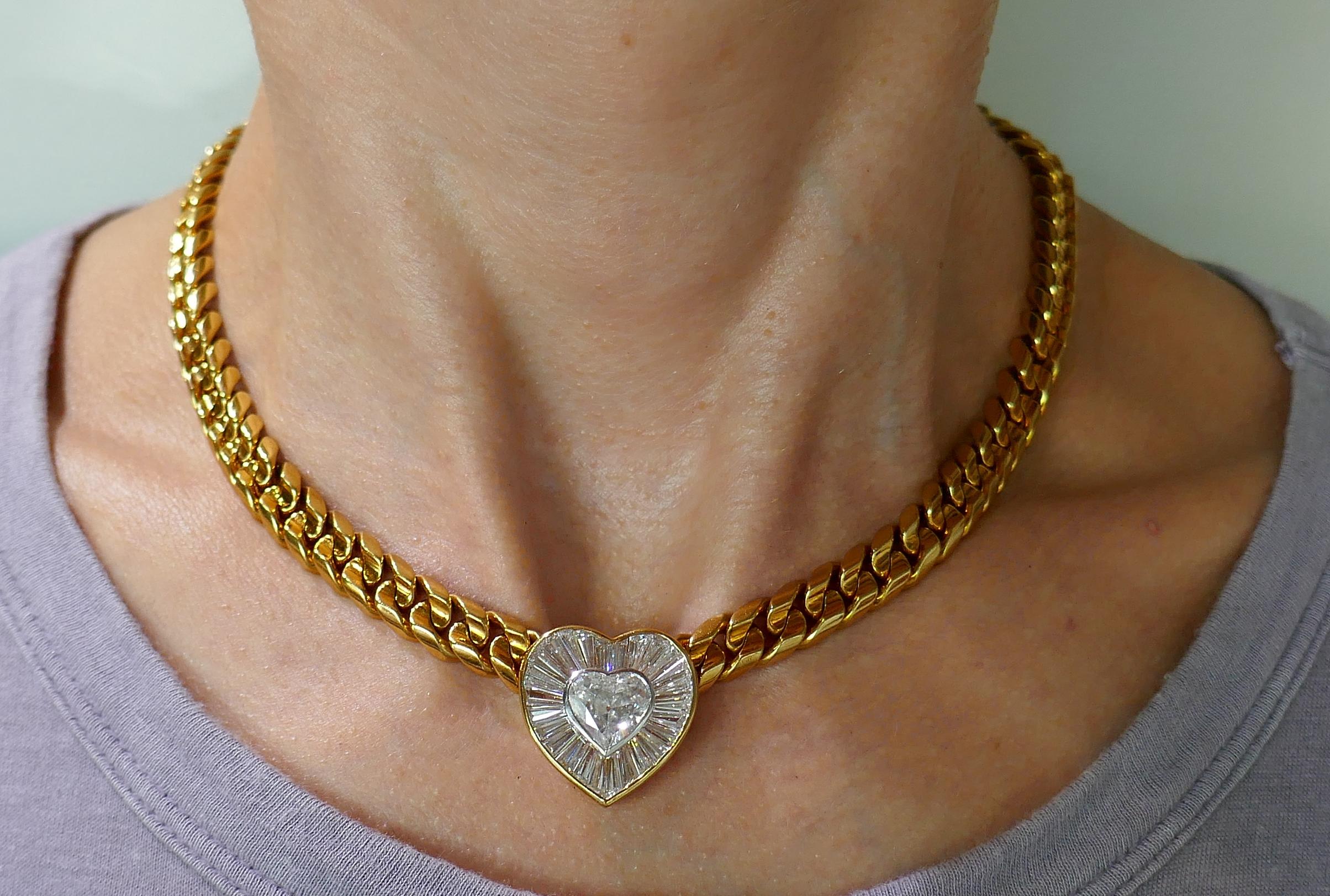 Gorgeous classy diamond and yellow gold necklace created by Bulgari in Italy in the 1980's. It features a 2.21-ct heart-shape diamond accented with a wide frame of baguette cut diamonds set in 18 karat yellow gold. 
The heart pendant is 7/8