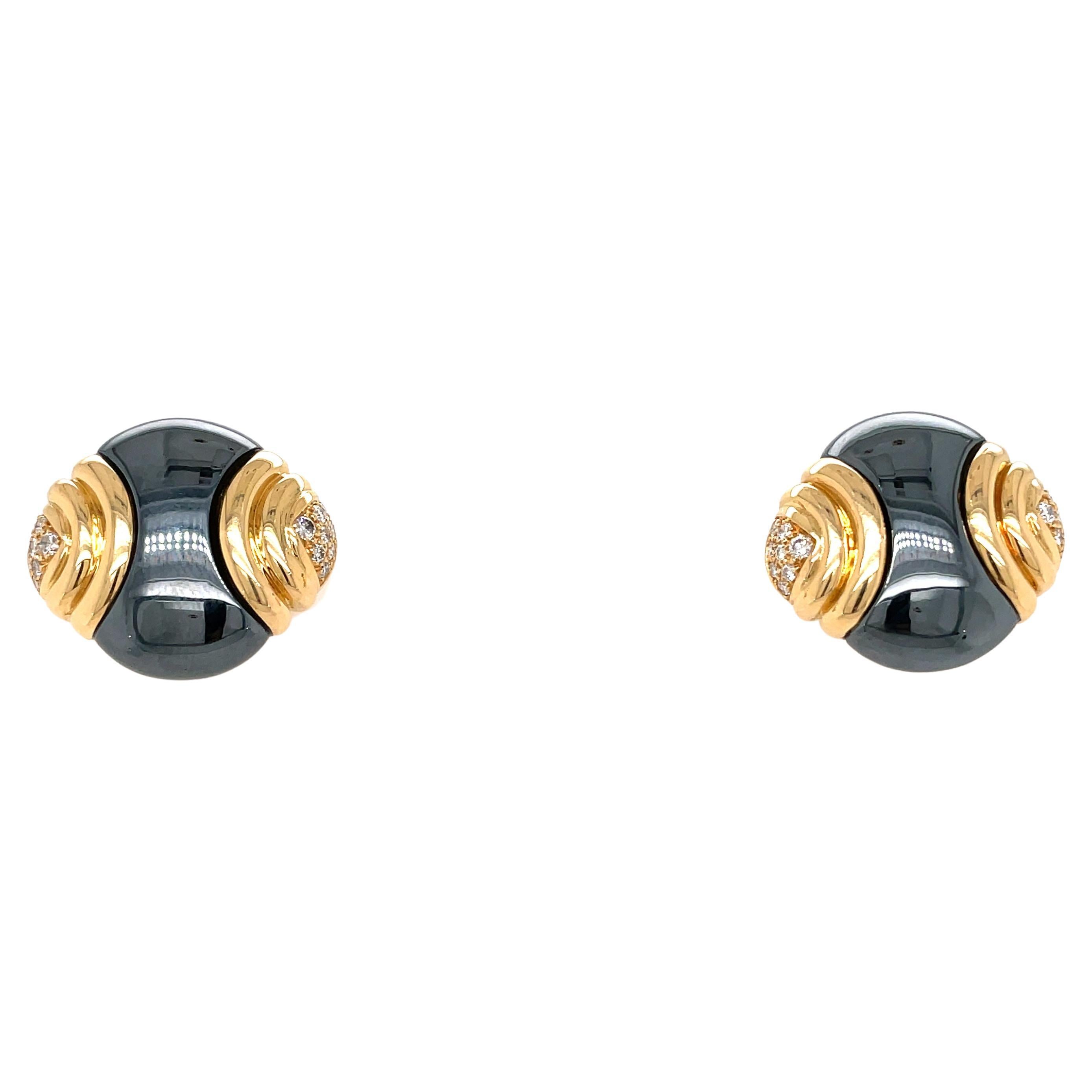 Iconic Bulgari design for these Bold rare earrings, designed and made in Italy in solid 18k yellow gold and black hematite, they feature sparkling colorless round brilliant cut diamonds at the two groove designed sides. Made in Italy, circa