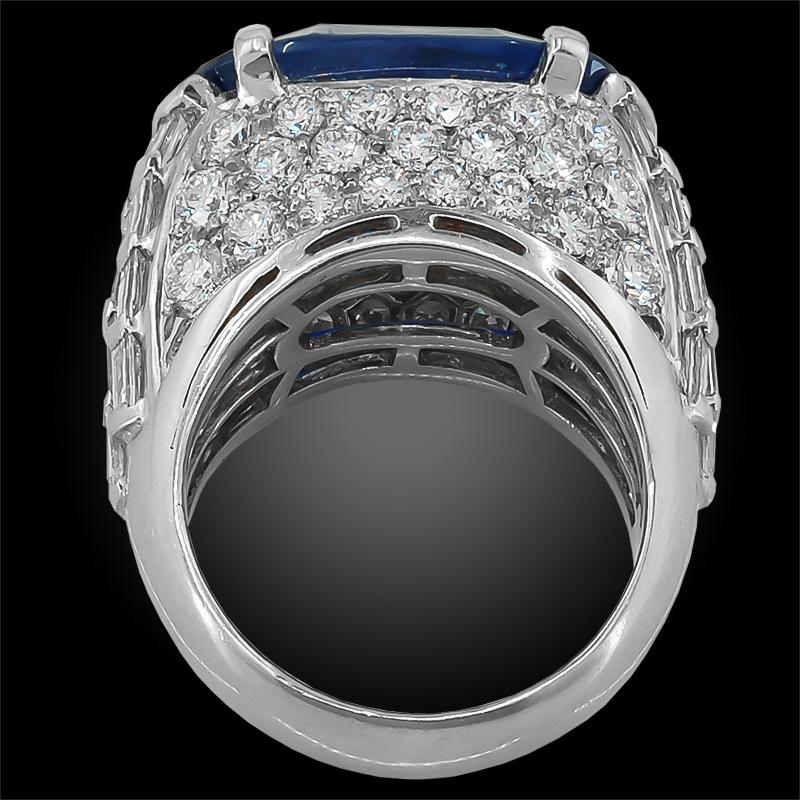 A fabulous ring by Bulgari, set at the center with an oval Ceylon No Heat sapphire of magnificent color, weighing approximately 13.68 carats with an AGL certificate. The sapphire is surrounded by square and step-cut diamond shoulders, pave set at