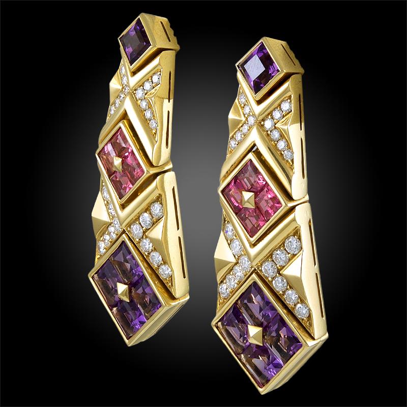 Exceptionally crafted by Bulgari, comprising a pair of uniquely designed hanging earrings that date back to the 1980’s, each made of 18k yellow gold, set with vibrant amethysts and pink sapphires, further accented with brilliant round cut diamonds.