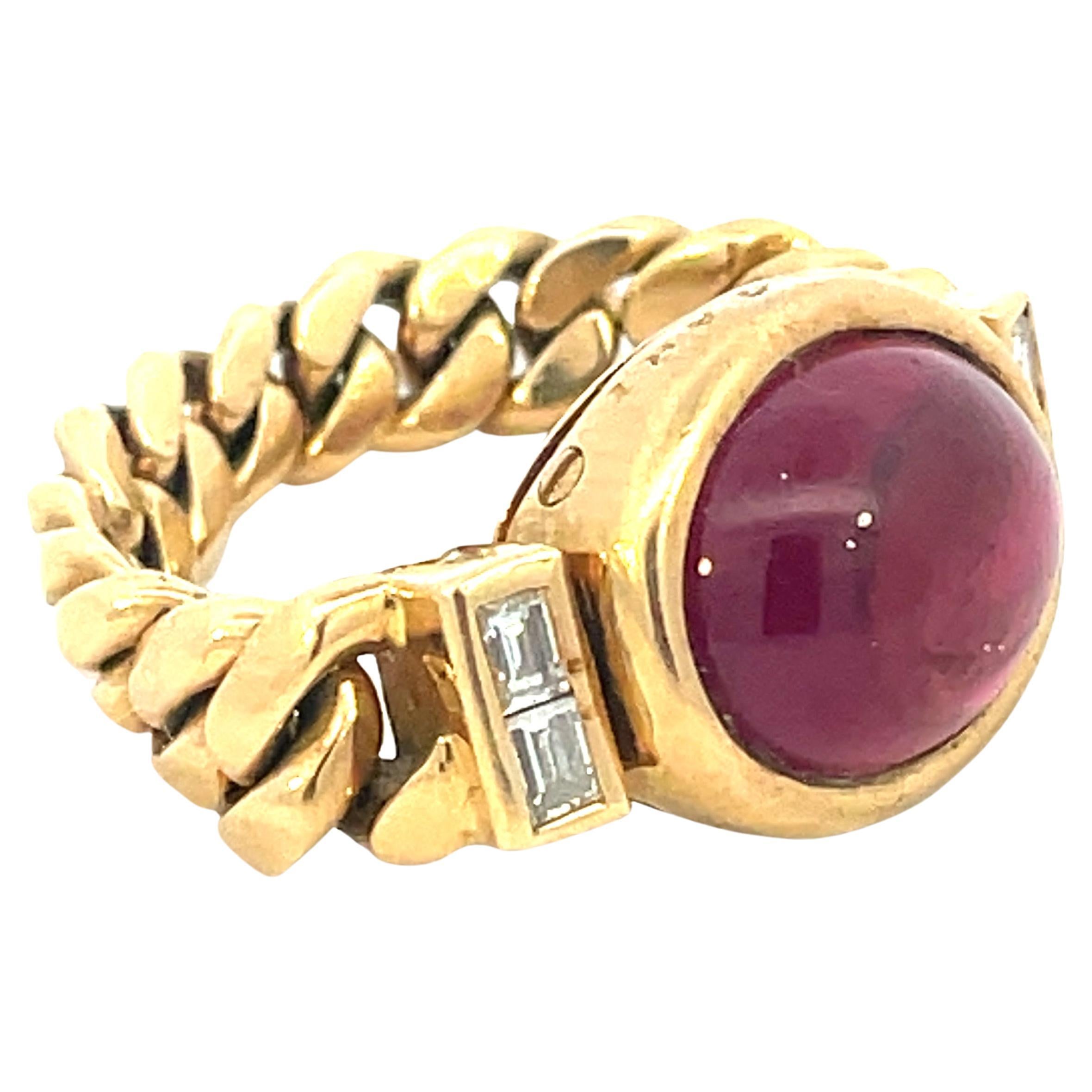 Beautifully designed and masterfully handcrafted by the famous Italian jeweler Bulgari, this ring features a vibrant Diamond Baguettes and a strongly saturated pink purple Tourmaline Cabochon
The approx weight of The Tourmaline is about 6
