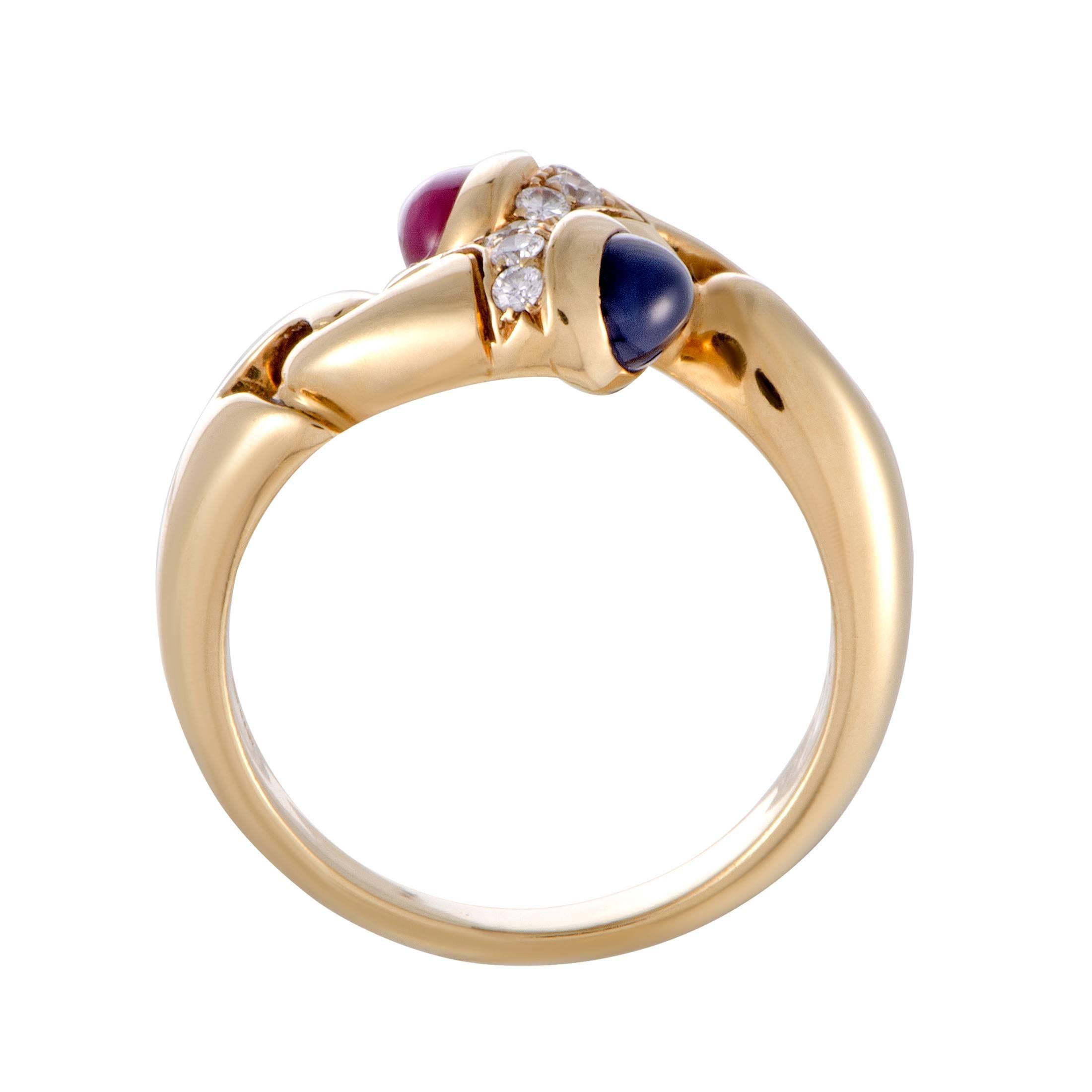 Designed by Bvlgari in a wonderfully unconventional manner, this superb ring is presented in luxurious 18K yellow gold and offers an incredibly eye-catching look. The ring is embellished with a splendid sapphire and a striking ruby that are