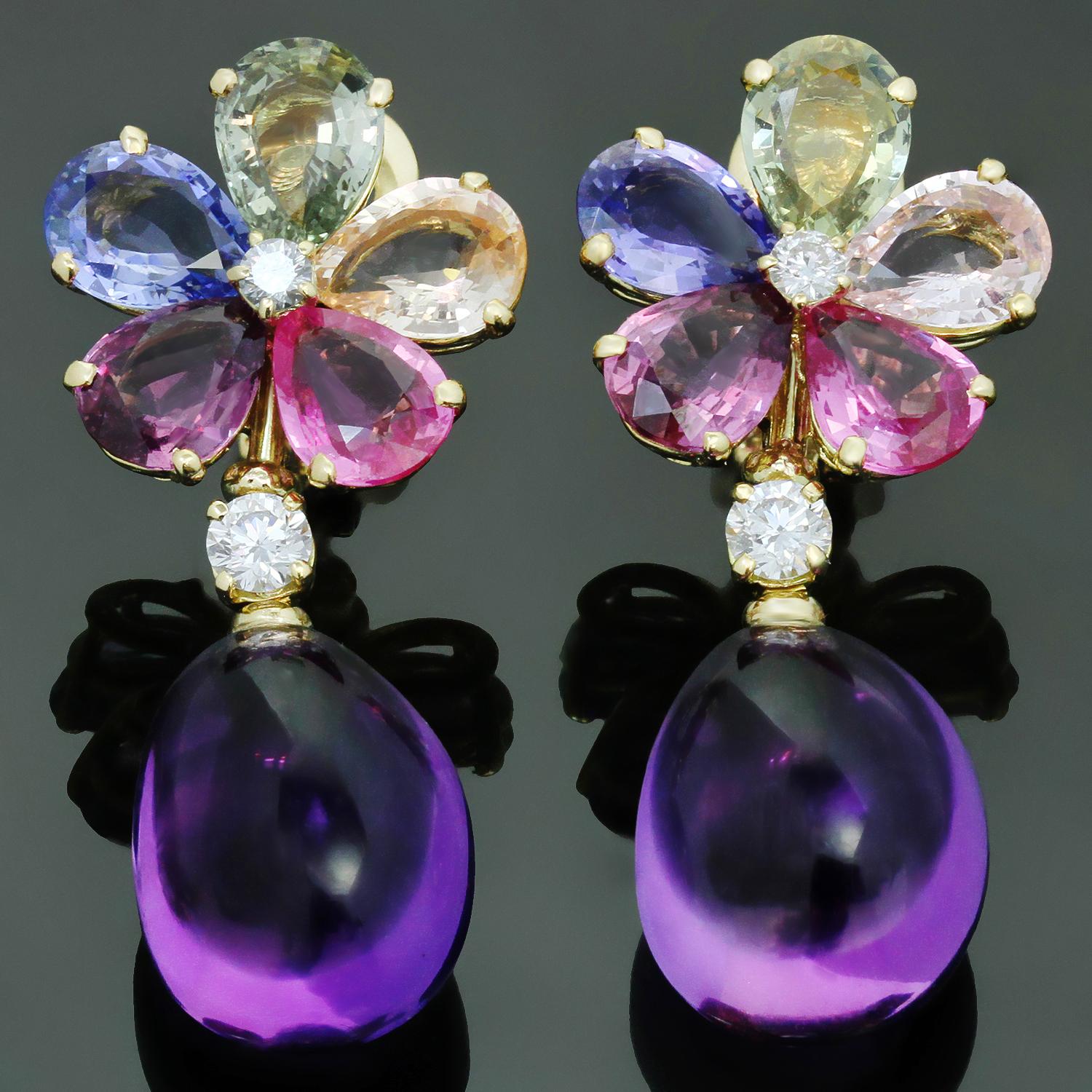 These fabulous Bulgari drop earrings are crafted in 18k yellow gold and feature sparkling florets of multicolored sapphires accented with brilliant-cut round diamonds and cabochon amethyst drops. The 10 multi-colored pear-shaped sapphires weigh an