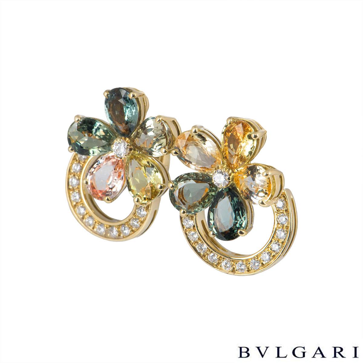 A beautiful pair of 18k yellow gold, diamond and sapphire earrings by Bvlgari from the Sapphire Flower collection. The earrings comprise of a flower motif composed of 5 fancy coloured pear shaped sapphires as petals with 12 round brilliant cut pave