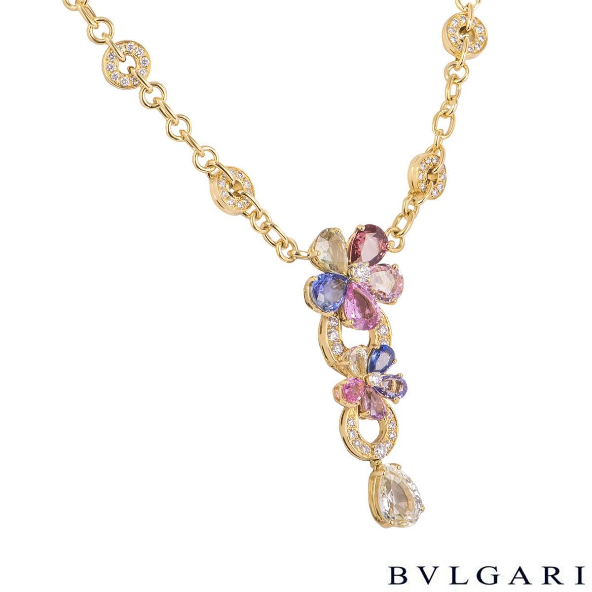 A beautiful 18k yellow gold, diamond and sapphire necklace by Bvlgari from the Sapphire Flower collection. The necklace features 2 flower motifs composed of 10 fancy coloured pear cut sapphires as petals, pave set diamonds on the iconic Bvlgari