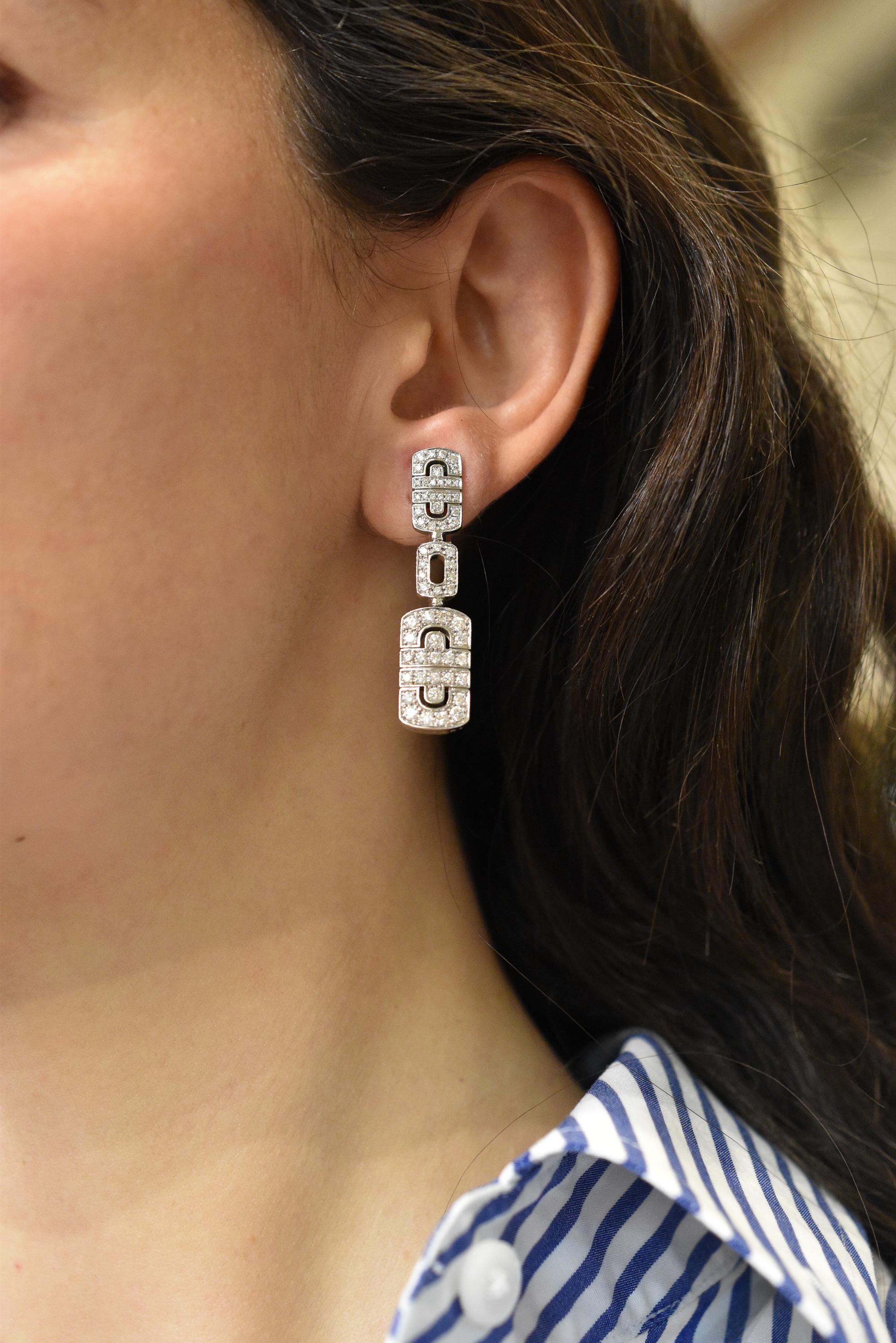 A stunning Bulgari 'Parentesi' Necklace and Pendant Earclip Suite. Made in Italy, circa 1990. 

This exquisite set features the iconic Parentesi design, with each piece pavé-set with brilliant-cut diamonds for a total of 6.75 carats in weight. The
