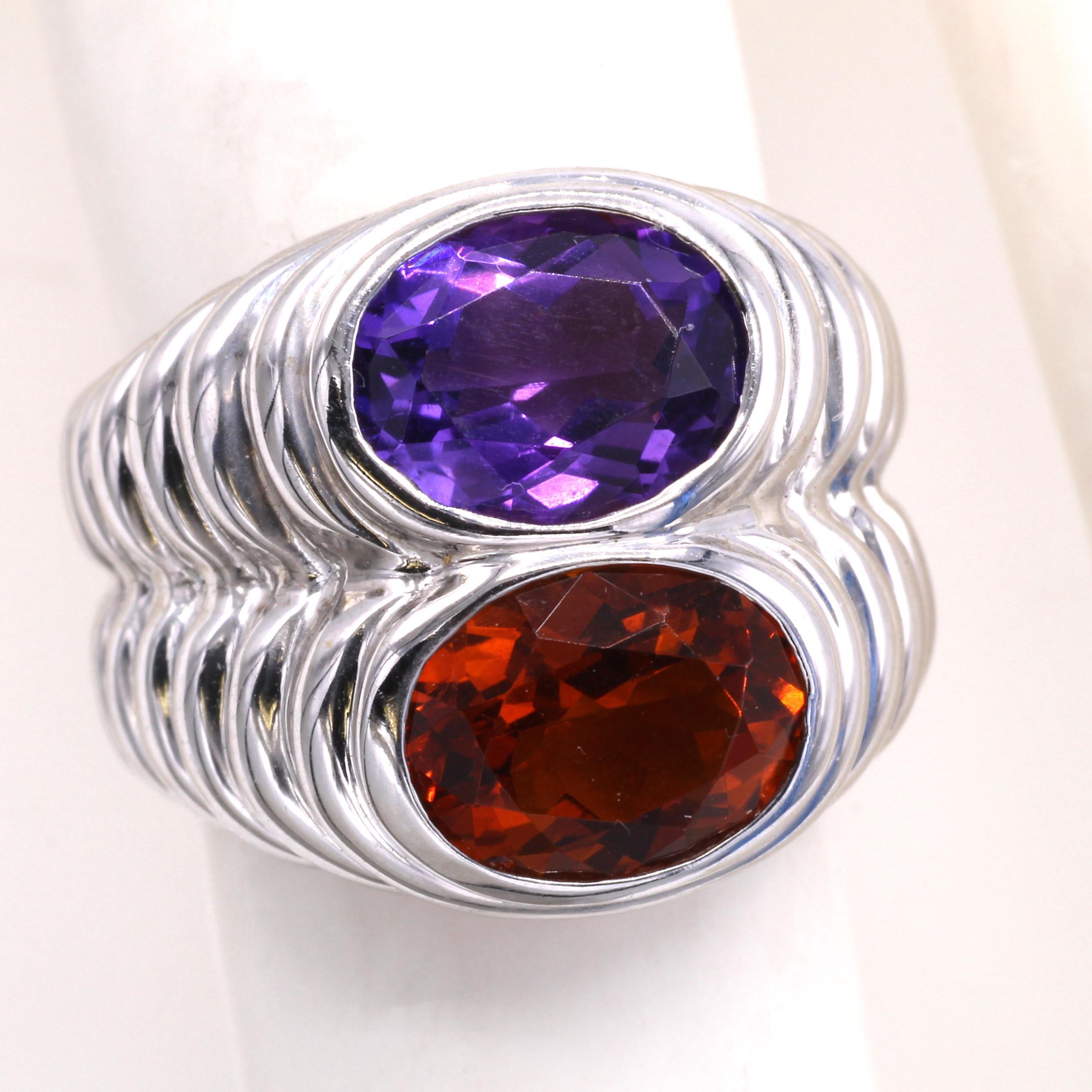 Beautifully designed and masterfully handcrafted by the famous Italian jeweler Bulgari, this ring features a vibrant deep orange Citrine and a strongly saturated velvety purple Amethyst , perfectly cut into matching ovals. This bold and fashionable