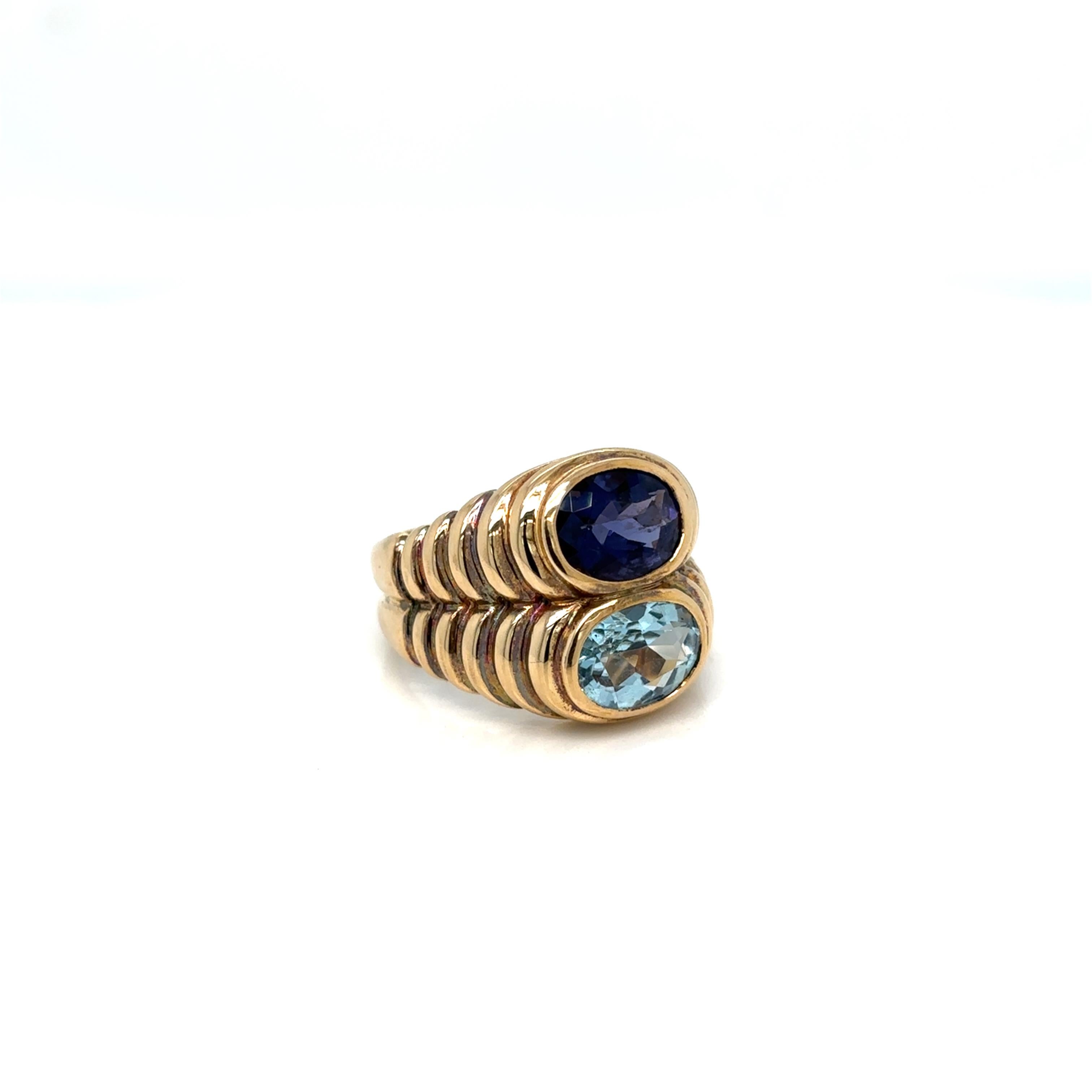 Bulgari Doppio Baccellato iconic ring, made of 18 yellow gold and set with natural oval shaped blue Topaz & Iolite. Circa 1980’
Size 6.5, resizable on request, total weight 12 grams

Stamped, with the maker's mark, the Italian gold assay hallmark