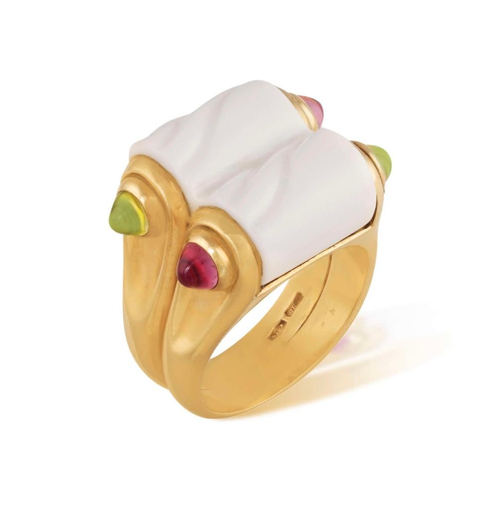 A beautiful ring in 18kt yellow gold and white porcelain. The central carved white porcelain, between green peridot and pink tourmaline cabochons shoulders, signed Bvlgari, Italian registry mark, with English import marks for 1995. 

Porcelain