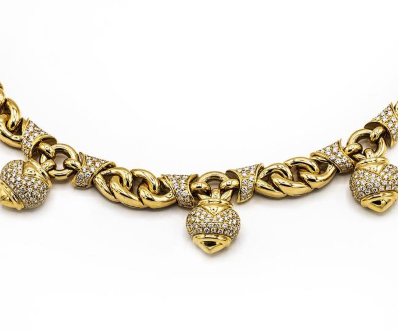 A stylish Bulgari 18 karat gold yellow necklace with heart pendants from the Doppio Cuore collection. Embellished with 320 round brilliant diamonds totaling approximately 5.25 carats, measuring 17 inches long. Made in Italy, circa 1980.