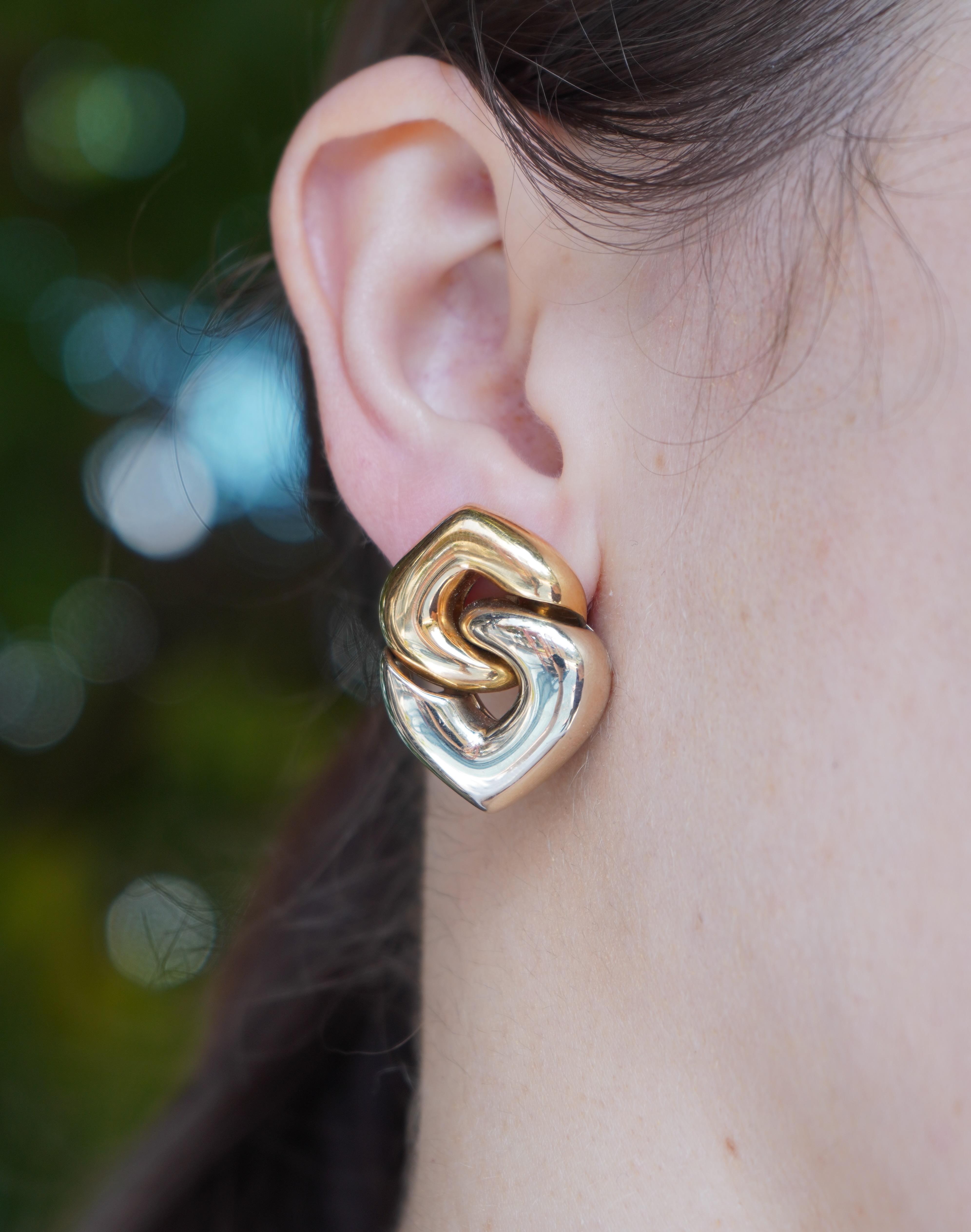 This vintage pair of Bulgari clip-on earrings, circa 1980s, showcases the brand’s iconic Doppio Cuore (Double Heart) design. Crafted from both 18k yellow and white gold, these earrings feature a unique interlocking heart motif, symbolizing unity and