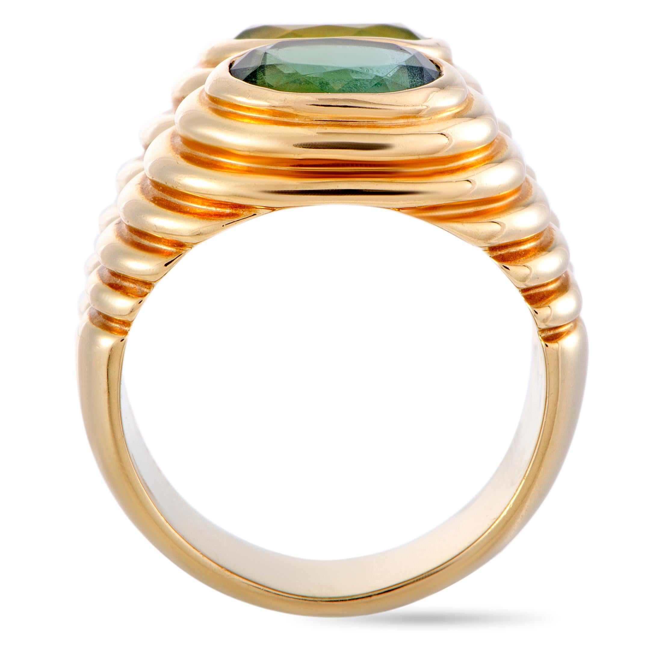 The Bvlgari “Doppio” ring is crafted from 18K yellow gold and set with a peridot and a tourmaline. The ring weighs 15.3 grams, boasting band thickness of 5 mm and top height of 5 mm, while top dimensions measure 15 by 10 mm.

This jewelry piece is