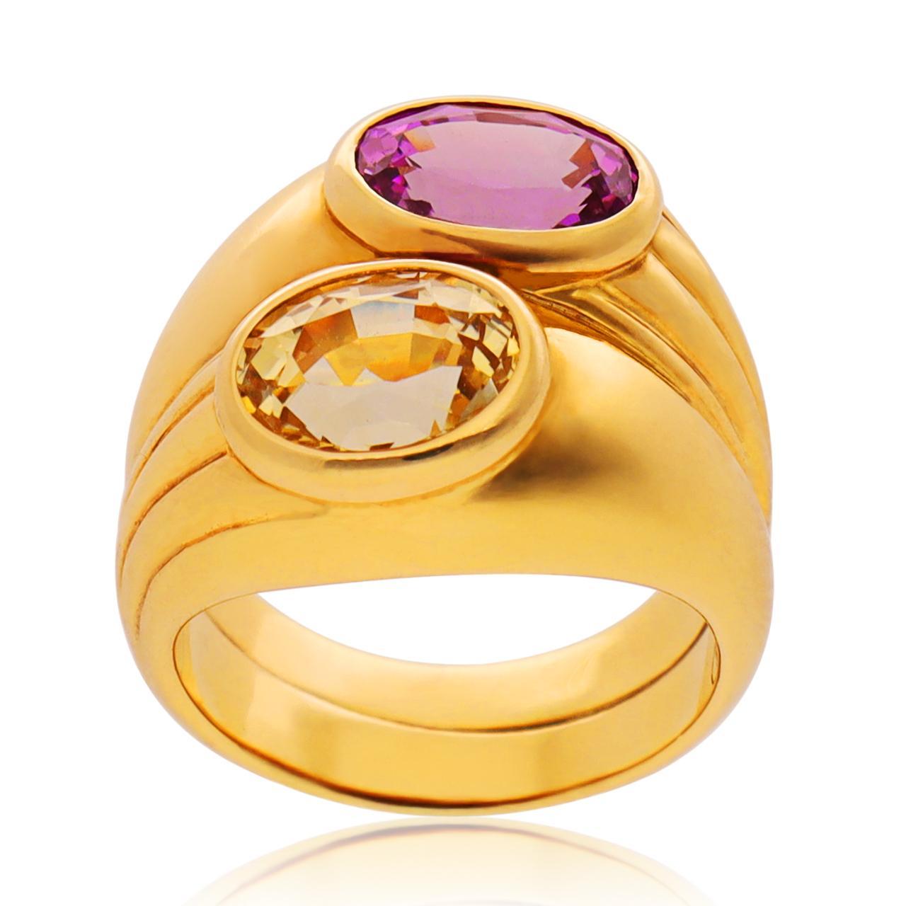 Crafted in Rome Italy and part of the iconic Doppio collection with alternating ribbed details in polished 18K yellow gold.

Approximate Oval Pink Sapphire Weight - 2.54 CTS
Approximate Oval Yellow Sapphire Weight - 2.87 CTS
Size 5.25
Circa -