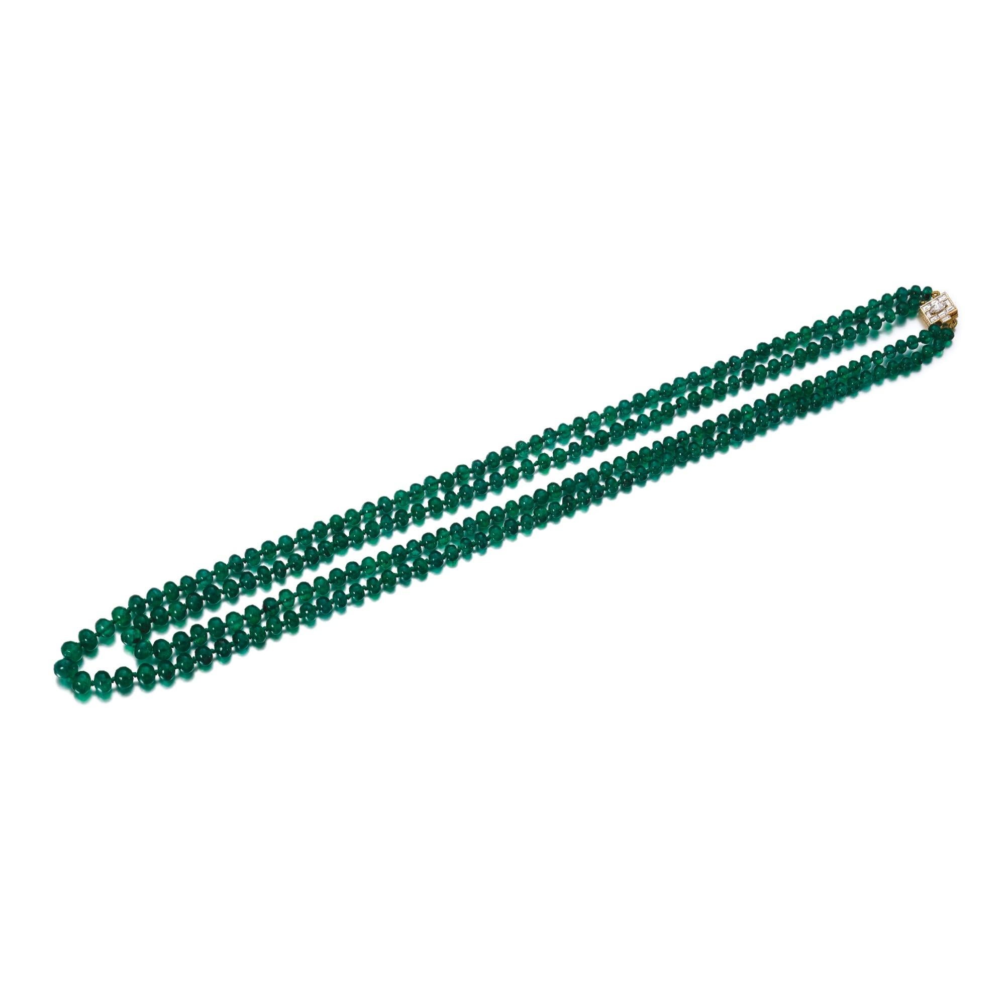 Bulgari long two-strand necklace of fine emerald beads, the clasp set with marquise and baguette diamonds. Made in Italy, circa 1960s.